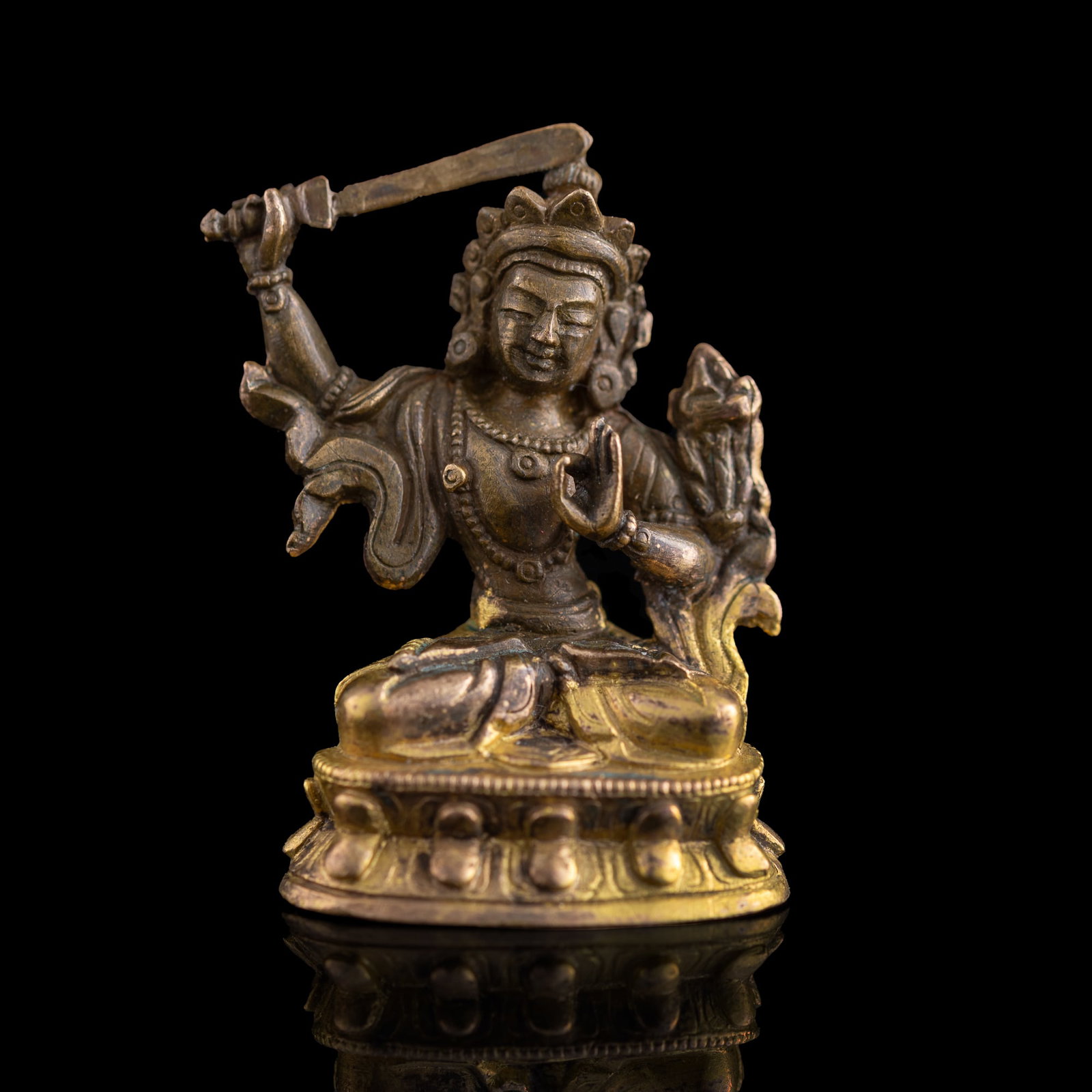 A Chinese gilt-bronze miniature Buddha figure, early 19th century: A Chinese gilt-bronze miniature Buddha figure early 19th century H: 1 1/2, W: 1, D: 3/4 in. (H: 3.81, W: 2.54, D: 1.91 cm.) Weight: 24 g Private collection, New York.