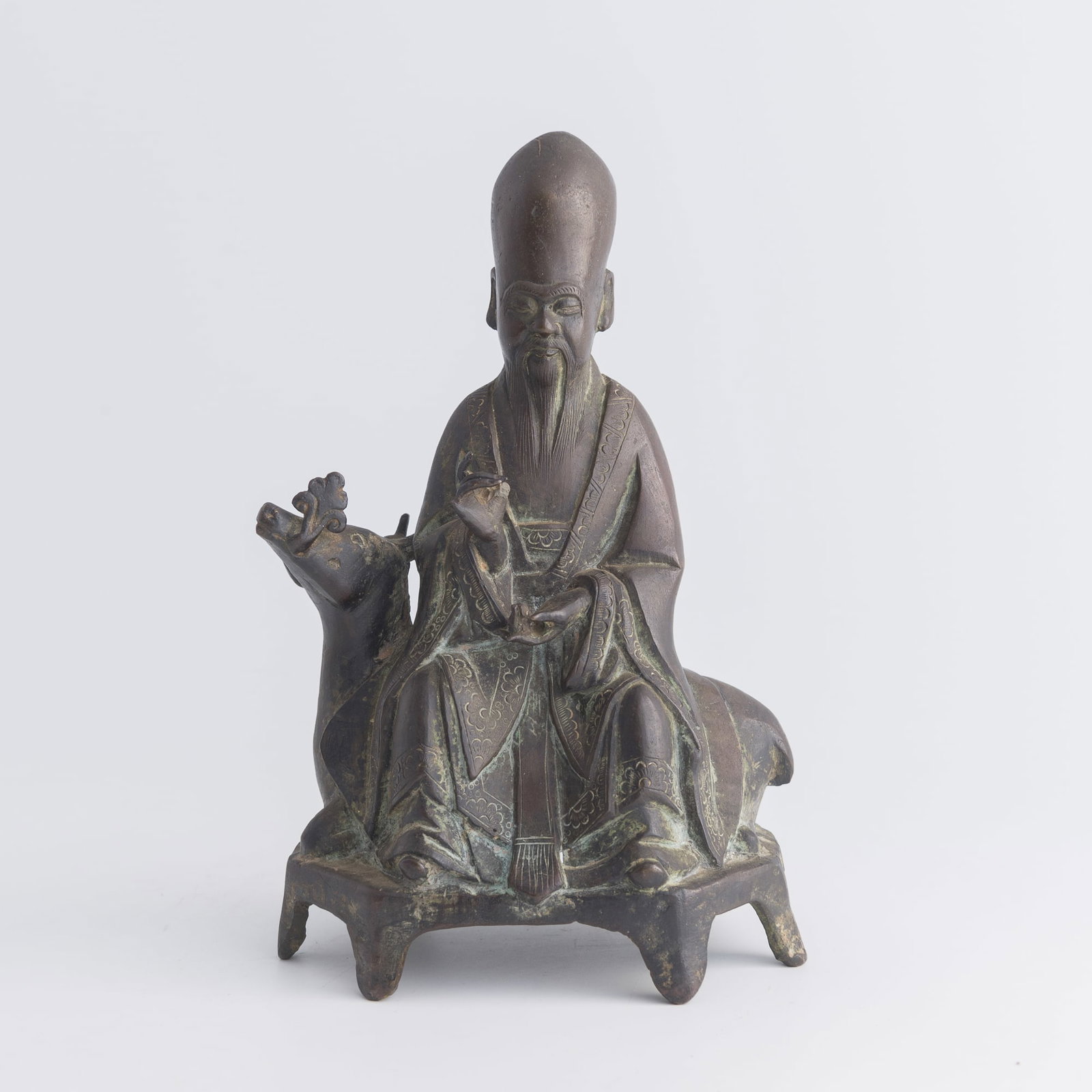 A Chinese bronze figure of Shouxing riding a deer, Ming dynasty: A Chinese bronze figure of Shouxing riding a deer Ming dynasty H: 8 1/2, W: 5 1/2, D: 3 1/2 in. (H: 21.6, W: 14, D: 8.9 cm.) Weight: 1156 g Private estate, Carlsbad, California.