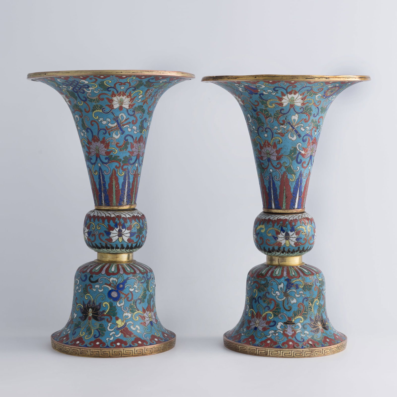 A pair of Chinese cloisonne gu vases, late 18th/early 19th century: A pair of Chinese cloisonne gu vases late 18th/early 19th century H: 13 1/8, Dia: 8 in. (H: 33.3, Dia: 20.3 cm. (each)) From Mr. Sheen, New York City, New York; acquired by his father-in-law. Christie