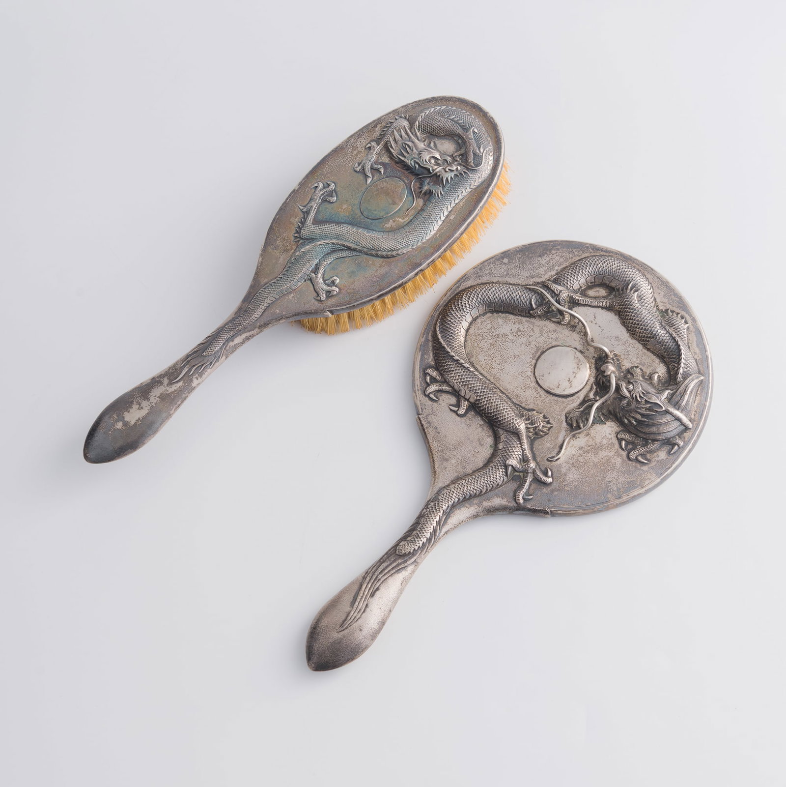 A Chinese silver mirror and a brush, Qing dynasty/Republic period: A Chinese silver mirror and a brush Qing dynasty/Republic period H: 10 1/2, W: 5 7/8, D: 7/8 in. (H: 26.7, W: 14.9, D: 2.2 cm. (largest)) Weight: 726.4 g (overall) From Ms. Chang, Flushing, New York; 
