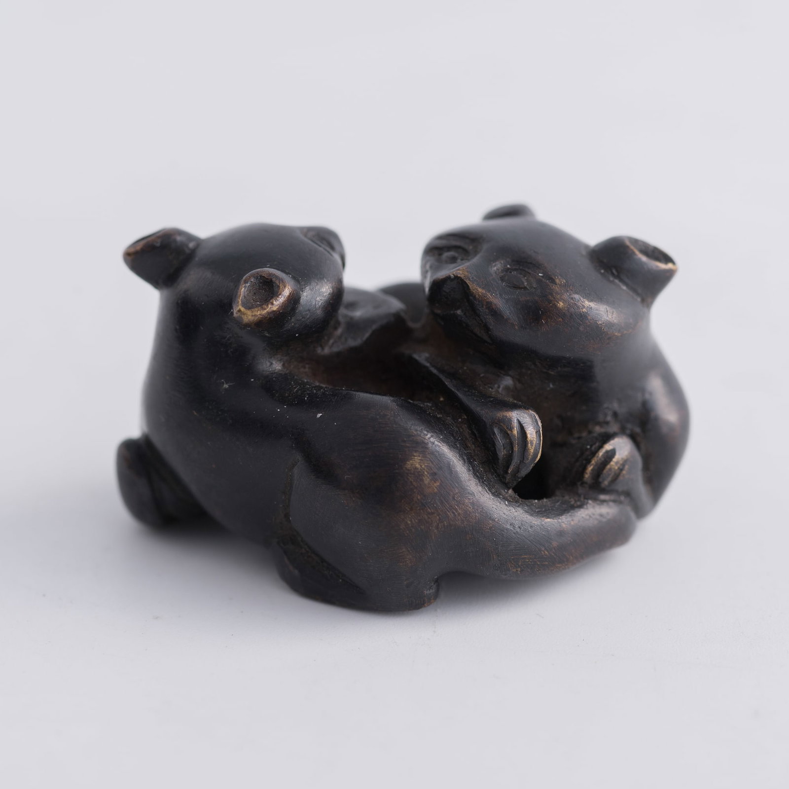 A Chinese bronze paperweight of two badgers, Ming dynasty: A Chinese bronze paperweight of two badgers Ming dynasty H: 1, W: 1 7/8, D: 1 3/8 in. (H: 2.5, W: 4.8, D: 3.5 cm.) Weight: 148.29 g From Mrs. Kiang in Newport Coast, California; collected by her late 