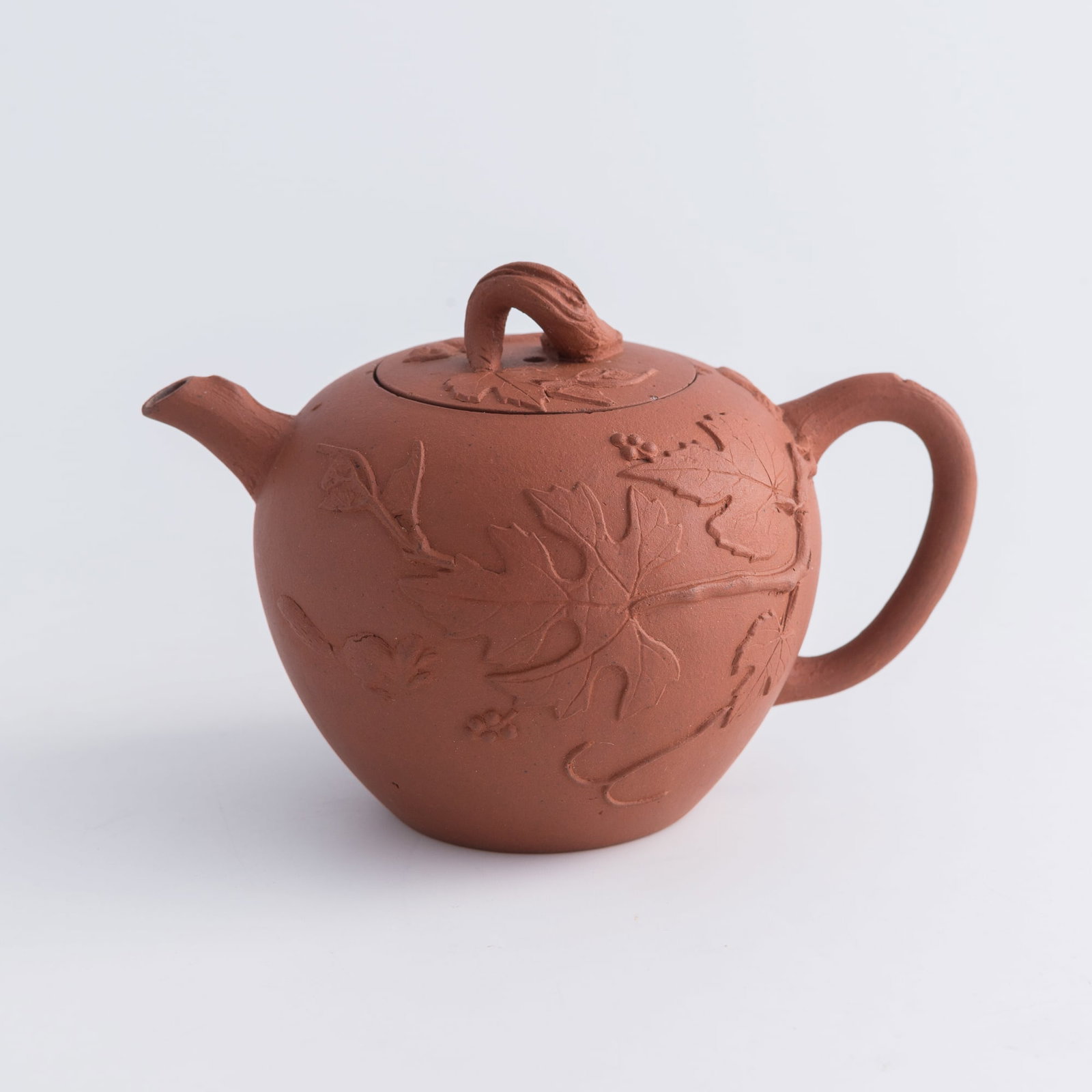 A Chinese zisha 'grape' teapot: A Chinese zisha 'grape' teapot H: 3 5/8, W: 5 5/8, D: 3 3/4 in. (H: 9.2, W: 14.3, D: 9.5 cm.) Private collection, Southern California. Click here for high resol