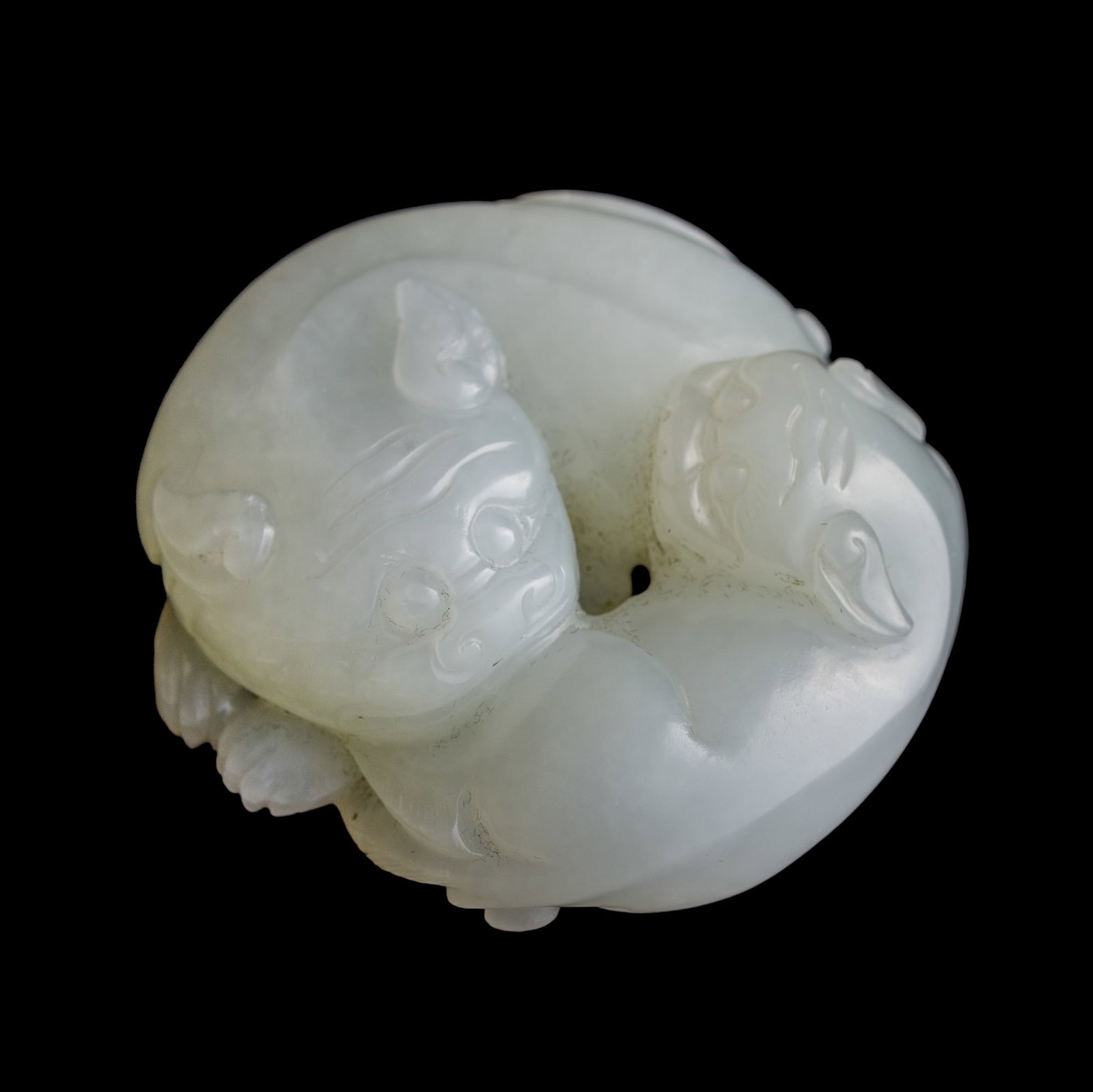 A Chinese white jade pendant of double badgers, 19th century: A Chinese white jade pendant of double badgers 19th century H: 7/8, W: 2 1/8, D: 2 in. (H: 2.2, W: 5.4, D: 5.1 cm.) From Mrs. Kiang in Newport Coast, California; collected by her late husband.
