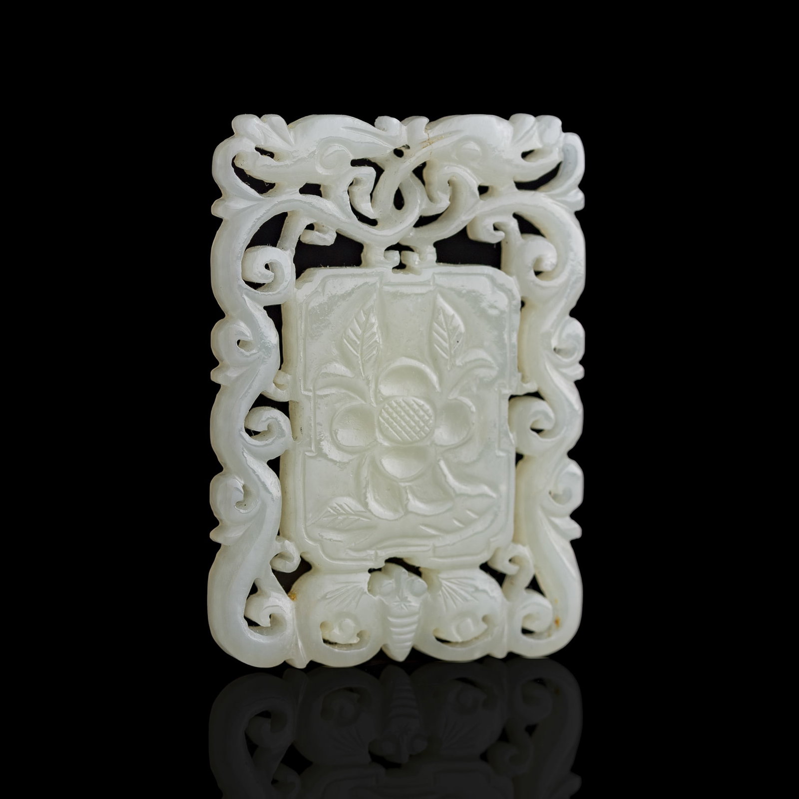 A Chinese reticulated white jade 'floral' plaque, 19th century (1 of 8)