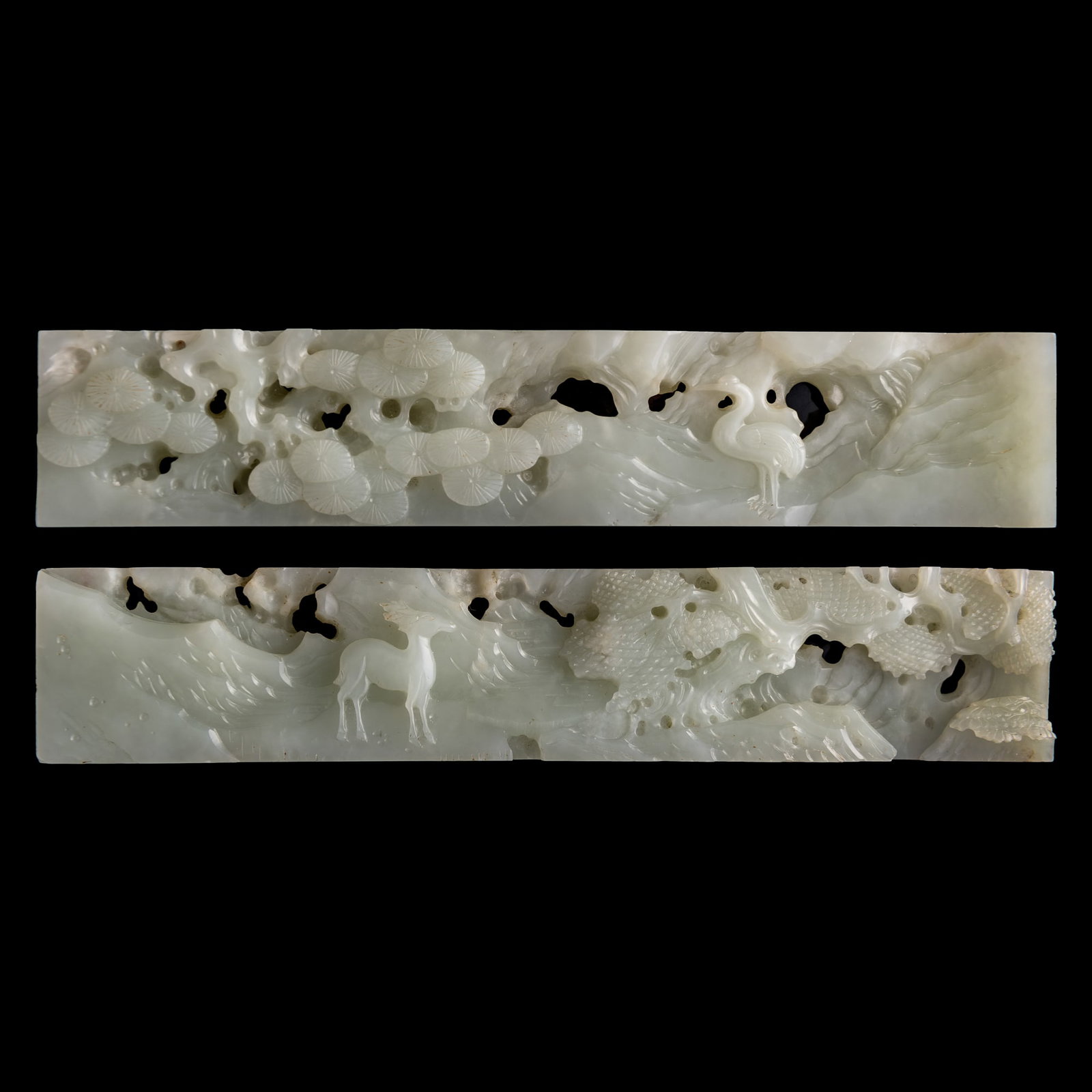 A pair of Chinese reticulated white jade 'pine and crane' paperweights, 18th century: A pair of Chinese reticulated white jade 'pine and crane' paperweights 18th century H: 1 3/8, W: 7 1/8, D: 5/8 in. (H: 3.5, W: 18.1, D: 1.6 cm. (each)) Private collection, Charlottesville, Virginia.