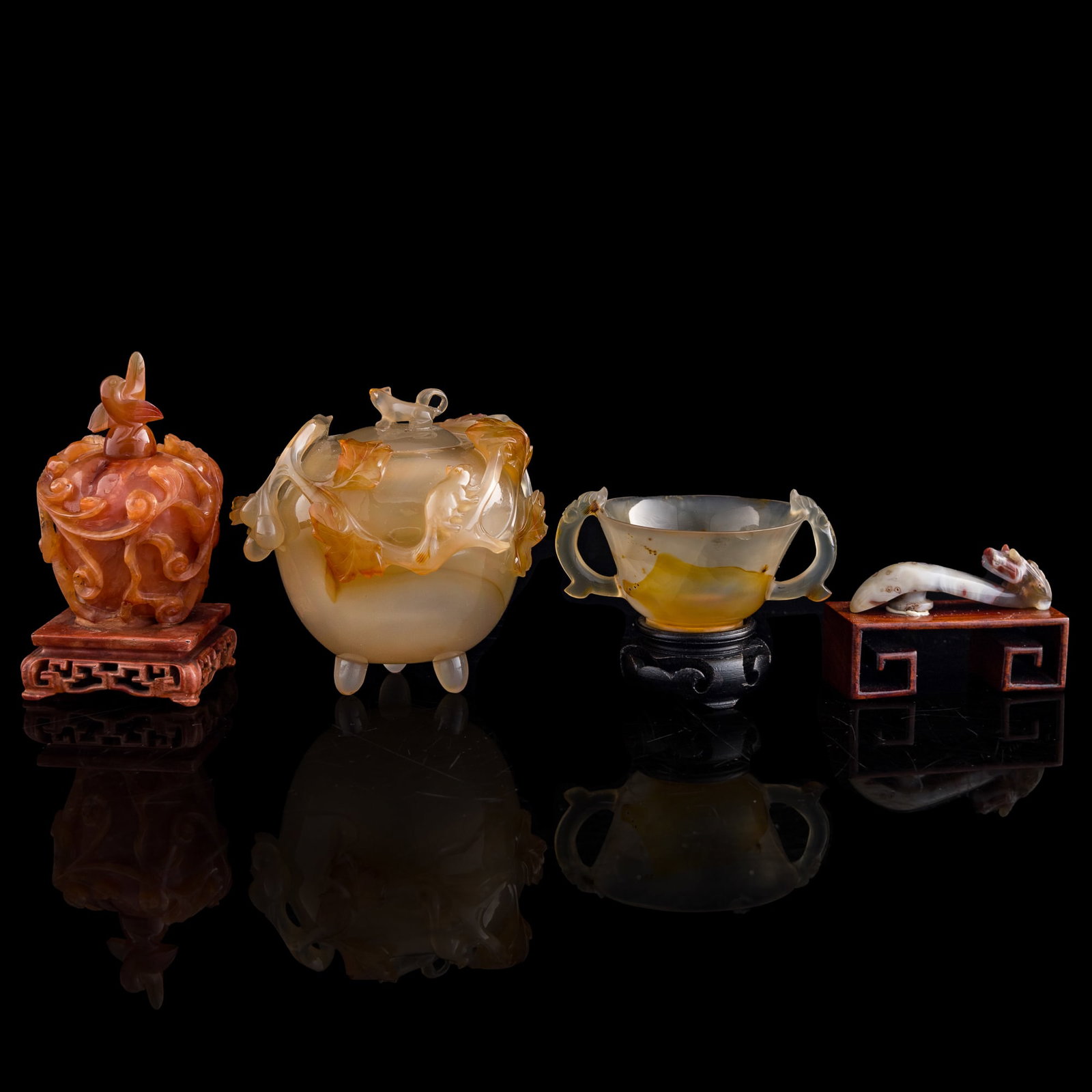 Four assorted Chinese agate ornaments, Ming/Qing dynasty: Four assorted Chinese agate ornaments Ming/Qing dynasty Comprising two lidded water coupes, a cup and a dragon hook. One with collection label from The Jade Dragon, Ann Arbor, Michigan, numbered 15553