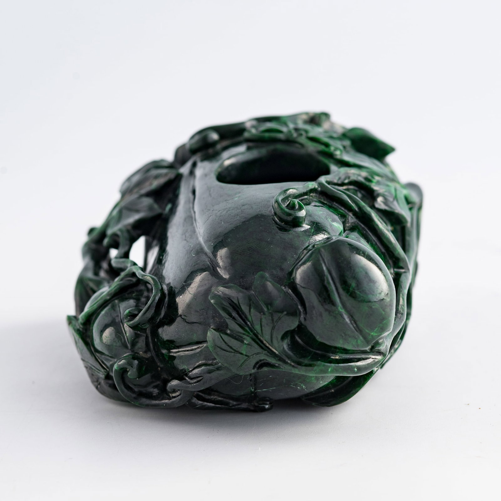 A Chinese malachite melon-form water coupe, 19th century: A Chinese malachite melon-form water coupe 19th century H: 2 1/4, W: 4 3/4, D: 3 1/2 in. (H: 5.7, W: 12.1, D: 8.9 cm.) Weight: 727.8 g Private collection, Charlottesville, Virginia. Click here for