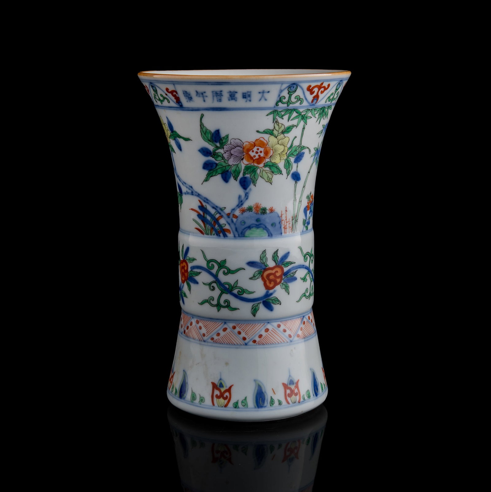 A Chinese blue and wucai gu vase, Republic period: A Chinese blue and wucai gu vase Republic period With six-character mark to upper body. H: 9 3/8. Dia: 5 7/8 in. (H: 23.8, Dia: 14.9 cm.) From Mrs. Chang, San Diego, California; inherited from her mot