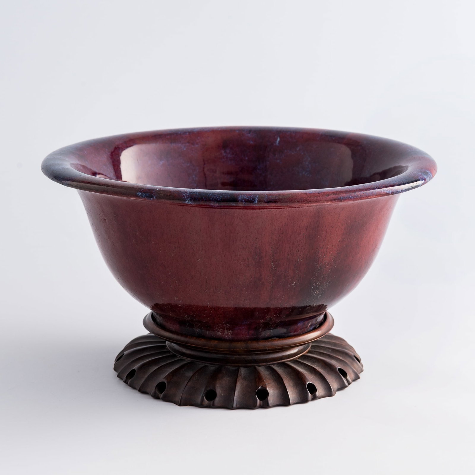 A large Chinese flambé bowl, 19th century: A large Chinese flambé bowl 19th century Sold with an old iron box and a hardwood stand. H: 4 1/2, Dia: 10 1/4 in. (H: 11.4, Dia: 26 cm. (bowl)) From Mr. Shih, Torrance, California; inherited from hi