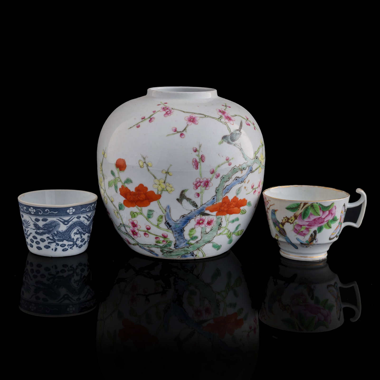 A Chinese jar and two cups, Qing dynasty/Republic period: A Chinese jar and two cups Qing dynasty/Republic period Comprising a famille rose jar, a famille rose cup, and a blue and white cup. (3). H: 6 1/2, Dia: 6 5/8 in. (H: 16.5, Dia: 16.8 cm. (largest)) Pr
