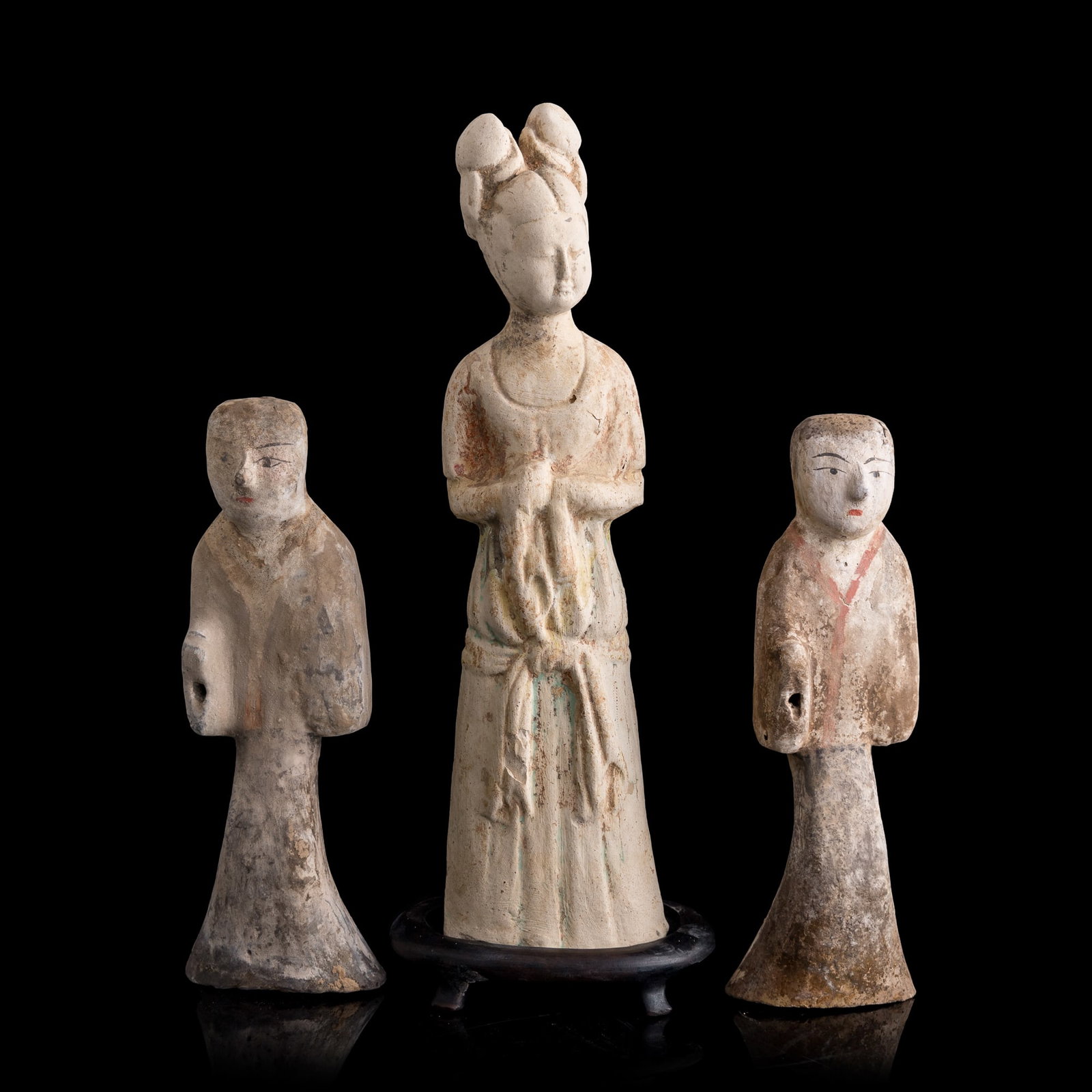 A set of three Chinese pottery figures, Tang dynasty: A set of three Chinese pottery figures Tang dynasty Sold with one wooden stand. (3). H: 12 1/8, W: 3 1/2, D: 2 3/8 in. (H: 30.8, W: 8.9, D: 6 cm. (tallest)) Private collection, Lovettsville, Virginia.