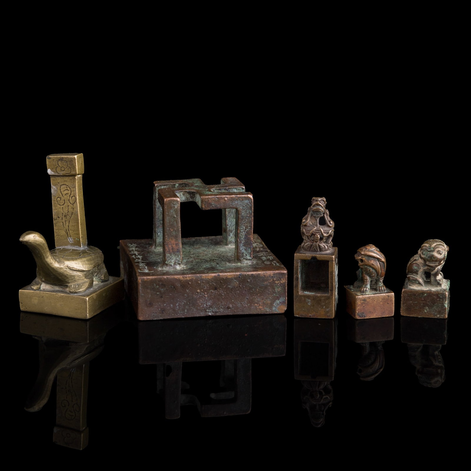 Five Chinese bronze and copper alloy seals, Qing dynasty/Republic period: Five Chinese bronze and copper alloy seals Qing dynasty/Republic period Four with character mark to underside. (5). H: 1 5/8, W: 2 1/8, D: 2 1/8 in. (H: 4.1, W: 5.4, D: 5.4 cm. (largest)) Weight: 638.
