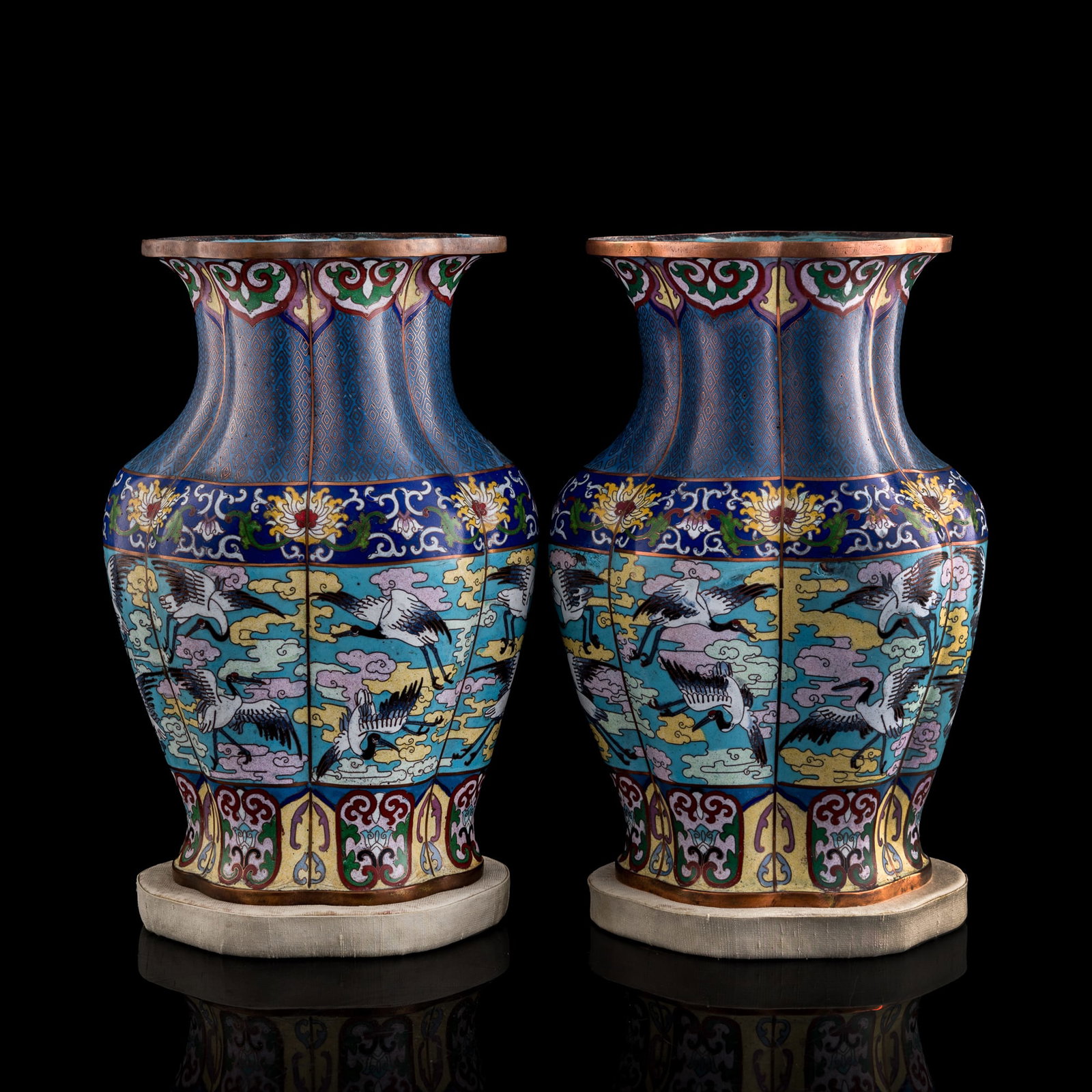 A pair of Chinese 'cranes amid clouds' cloisonne vases, Republic period: A pair of Chinese 'cranes amid clouds' cloisonne vases Republic period Sold with two fabric stands. (2). H: 12 1/4, W: 8 1/4, D: 5 1/4 in. (H: 31.1, W: 21, D: 13.3 cm. (vase, each)) Private