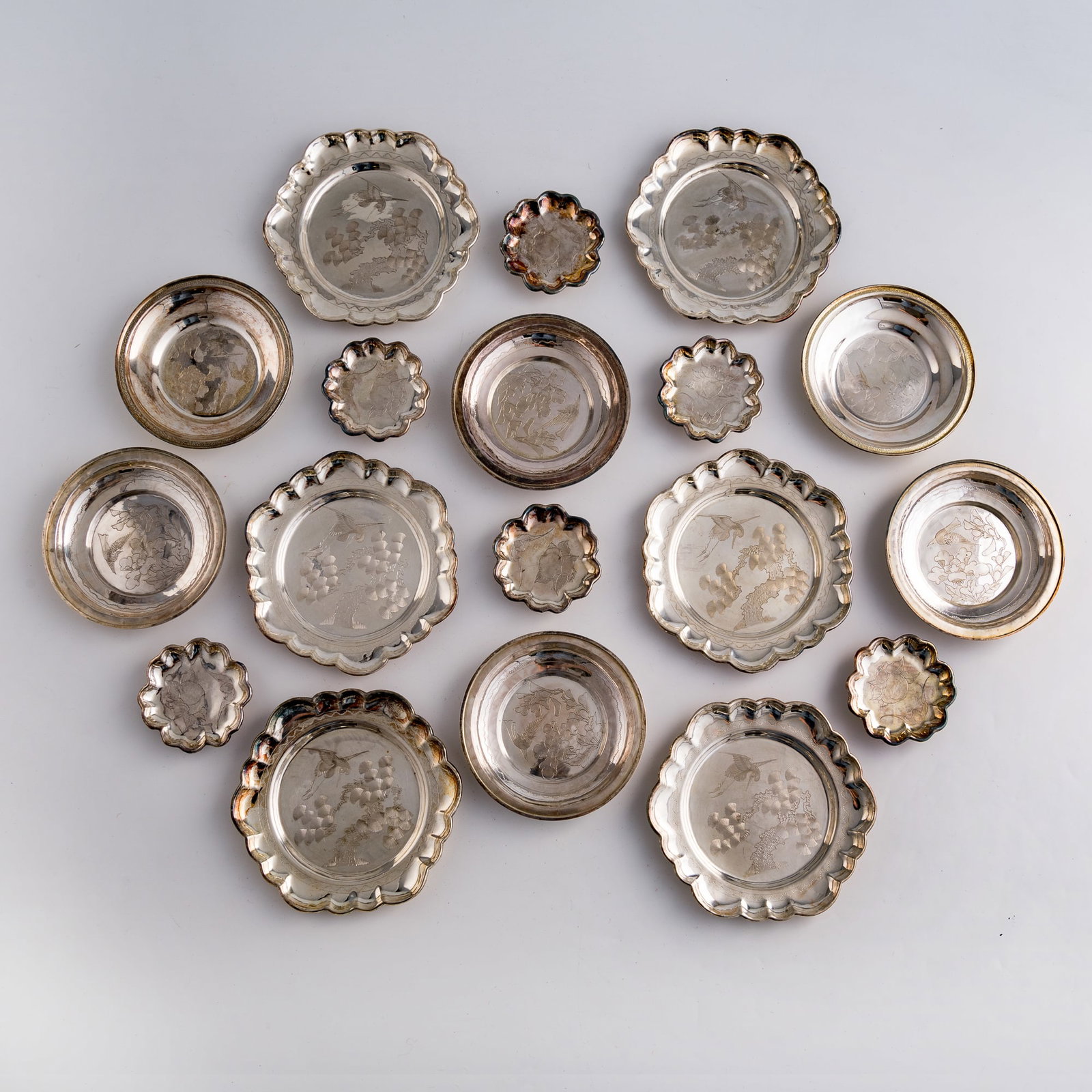 Eighteen Chinese silver dishes, Qing dynasty/Republic period: Eighteen Chinese silver dishes Qing dynasty/Republic period The undersides variously stamped with silver shop and maker's marks, including "Hengfu," "Laotianbao," "Fengxiangyu Ji," and "Xianglin." (18