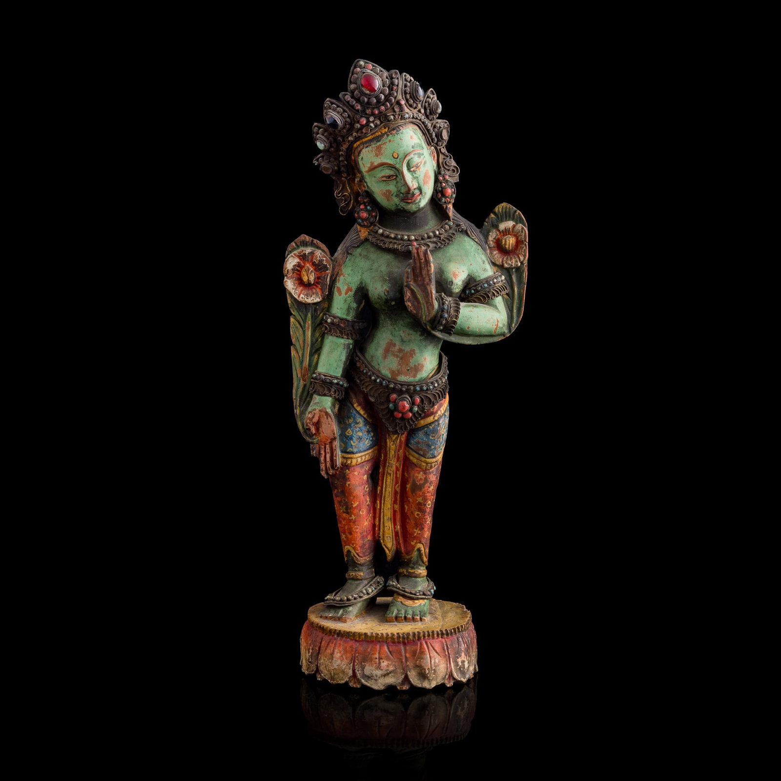 A Tibetan painted wood statue of Green Tara, 19th century: A Tibetan painted wood statue of Green Tara 19th century H: 14 3/4, W: 6 1/8, D: 4 1/4 in. (H: 37.5, W: 15.6, D: 10.8 cm.) Private collection, New York. Cli