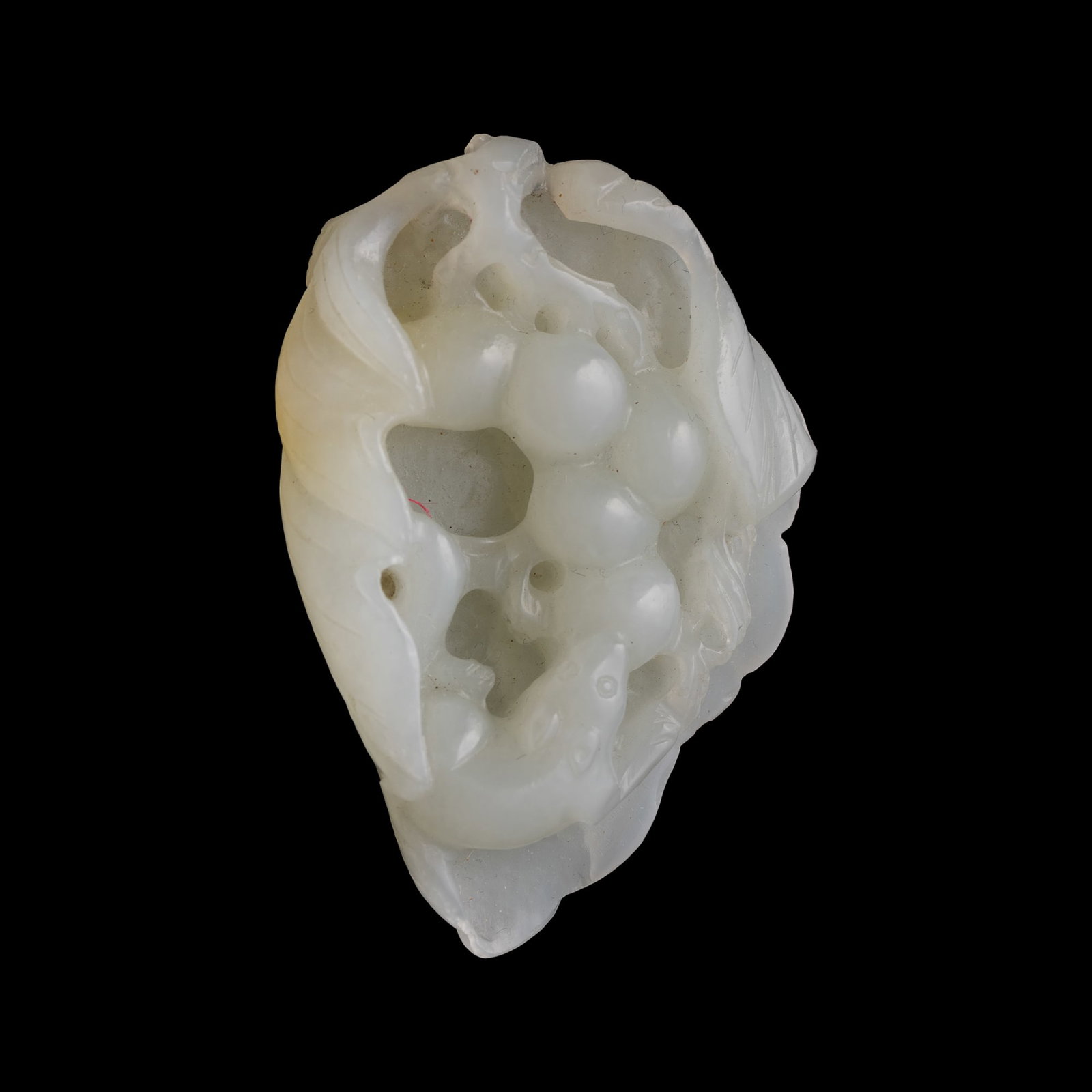 A Chinese white jade 'squirrel and grape' pendant, late 18th century: A Chinese white jade 'squirrel and grape' pendant late 18th century H: 2 1/2, W: 1 1/2, D: 3/4 in. (H: 6.4, W: 3.8, D: 1.9 cm.) Private collection, New York. Click here for high resolution images.