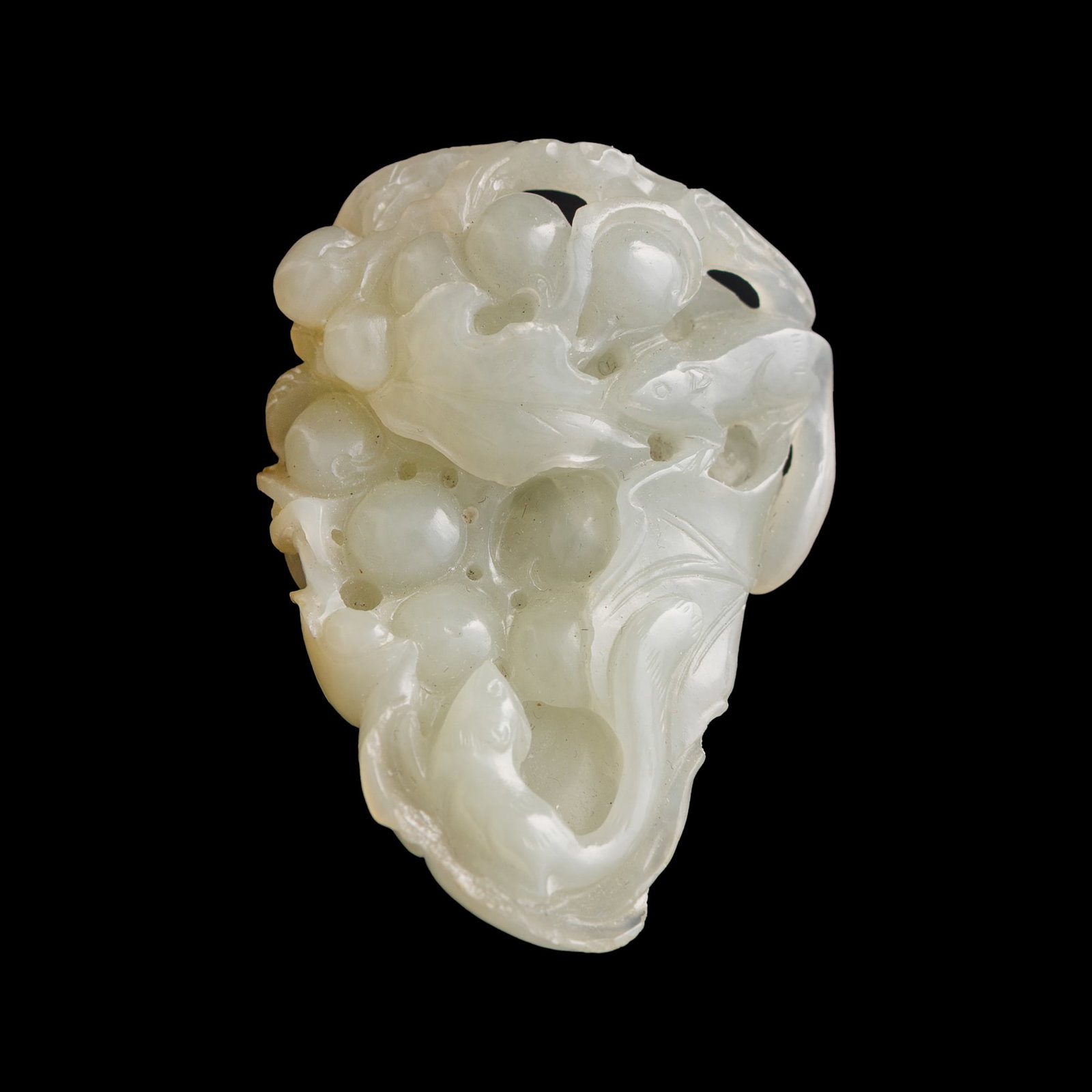 A Chinese jade 'squirrel and grape' pendant, late 18th century: A Chinese jade 'squirrel and grape' pendant late 18th century H: 2, W: 1 3/8, D: 7/8 in. (H: 5.1, W: 3.5, D: 2.2 cm.) Private collection, New York. Click here for high resolution images.
