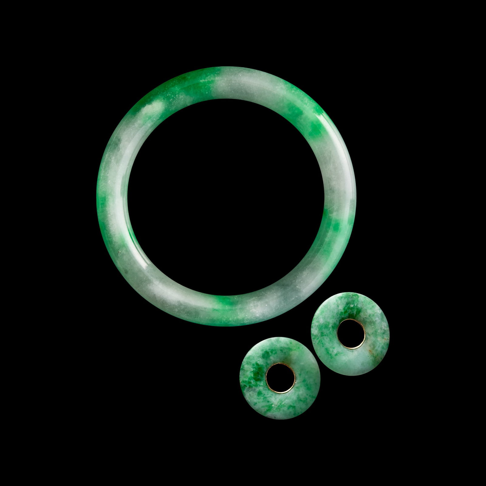 A Chinese bangle and a pair of bi-disc stud earrings, possibly jadeite (1 of 8)