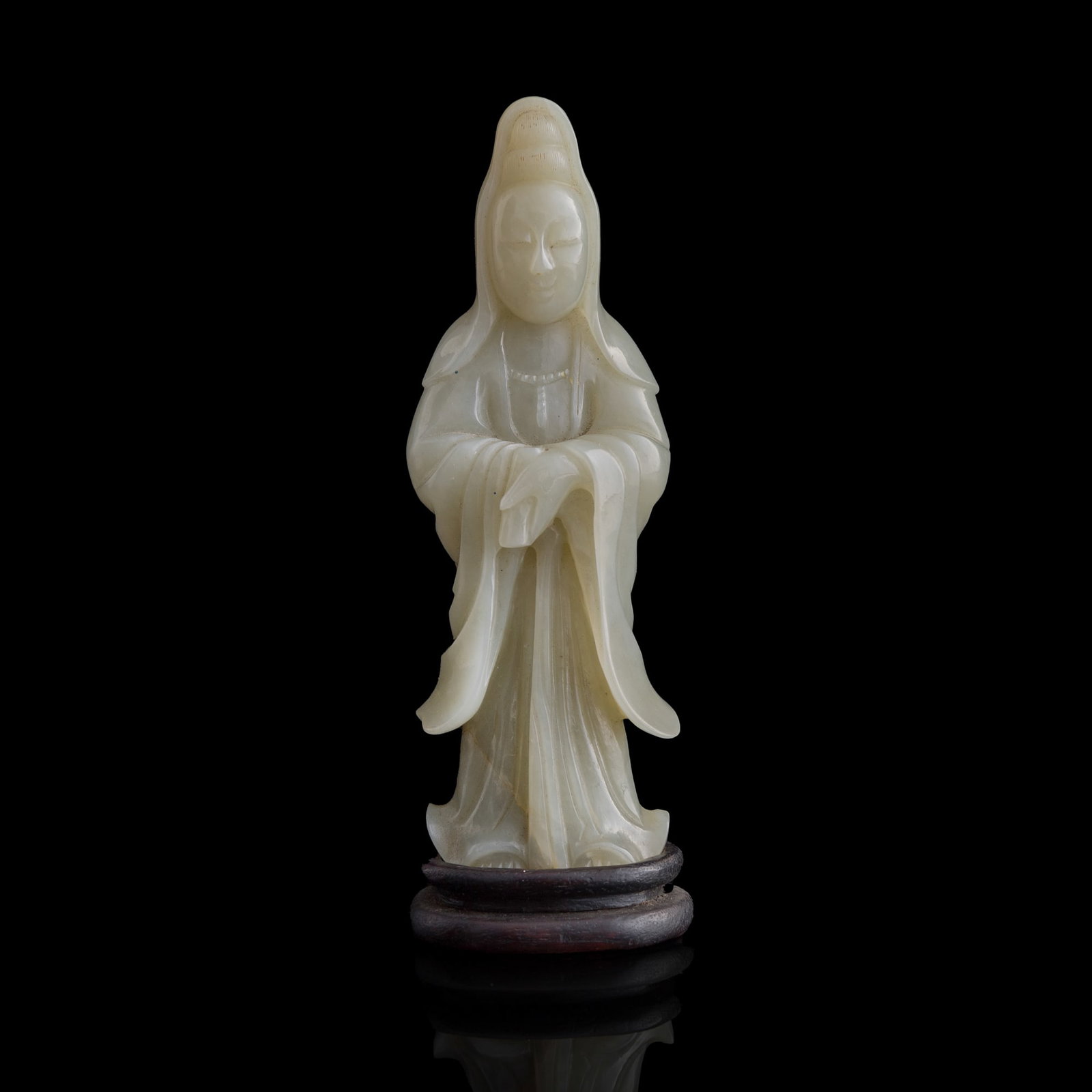 A Chinese jade carving of Guanyin, 18th century: A Chinese jade carving of Guanyin 18th century With original hardwood stand. H: 5 3/4, W: 2, D: 1 1/2 in. (H: 14.6, W: 5.1, D: 3.8 cm. (Guanyin)) Private collection, New York. Click here for high