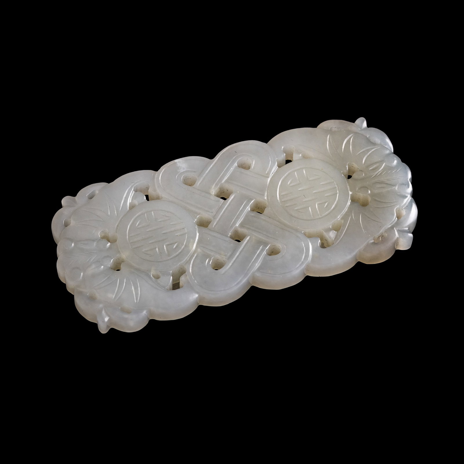 A Chinese carved white jade 'longevity' belt buckle, Qing dynasty: A Chinese carved white jade 'longevity' belt buckle Qing dynasty H: 1 3/8, W: 3 1/8, D: 5/8 in. (H: 3.5, W: 7.9, D: 1.6 cm.) Private collection, New York. Click here for high resolution images.