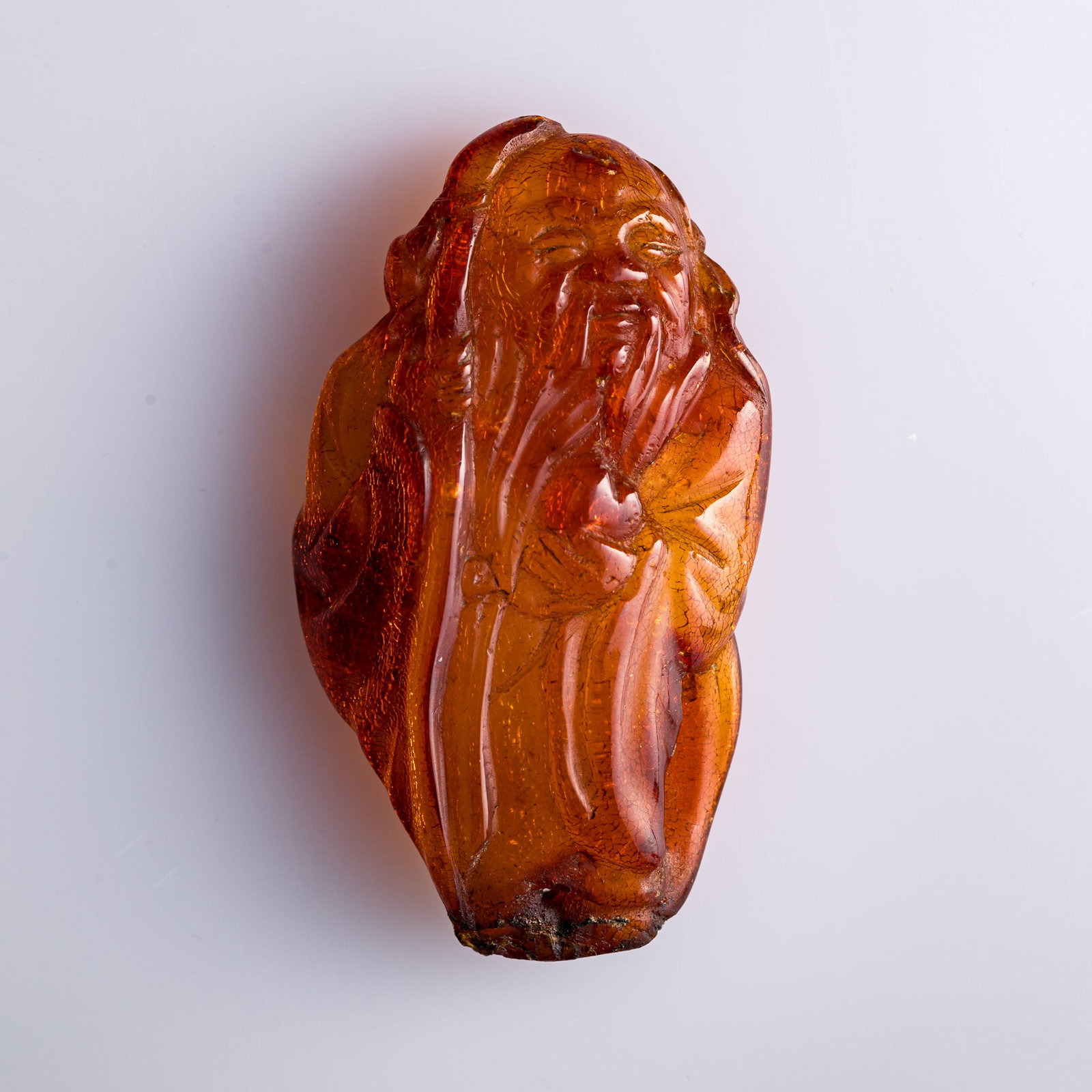 A Chinese amber carving of Shouxing, 18th century: A Chinese amber carving of Shouxing 18th century H: 2 1/2, W: 1 3/8, D: 1/2 in. (H: 6.4, W: 3.5, D: 1.3 cm.) Weight: 15.87 g Private collection, New York. Click here for high resolution images.