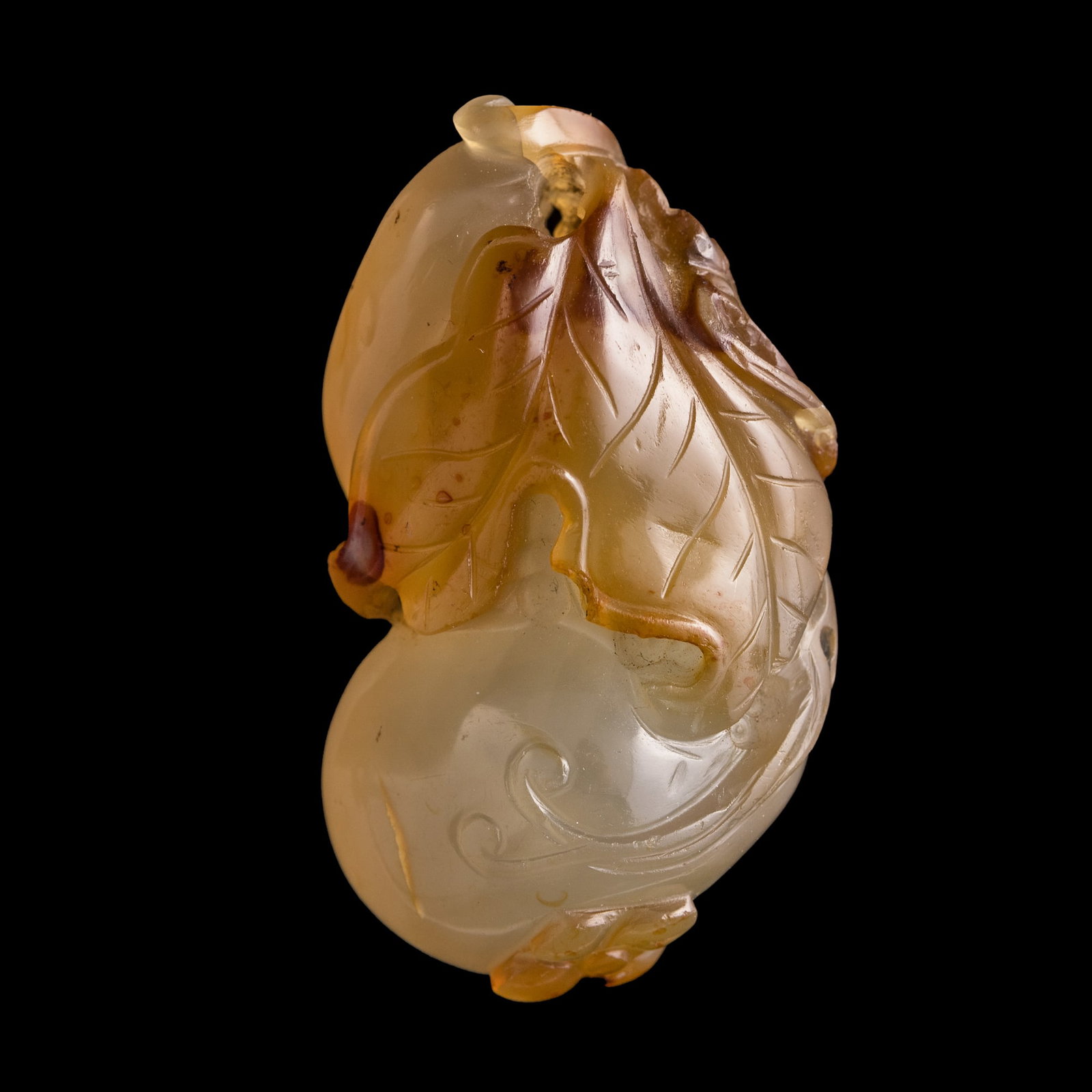 A Chinese agate gourd-form pendant, 18th/19th century: A Chinese agate gourd-form pendant 18th/19th century H: 2 1/8, W: 1 1/8, D: 1 in. (H: 5.4, W: 2.9, D: 2.5 cm.) Private collection, New York. Click here for high resolution images.