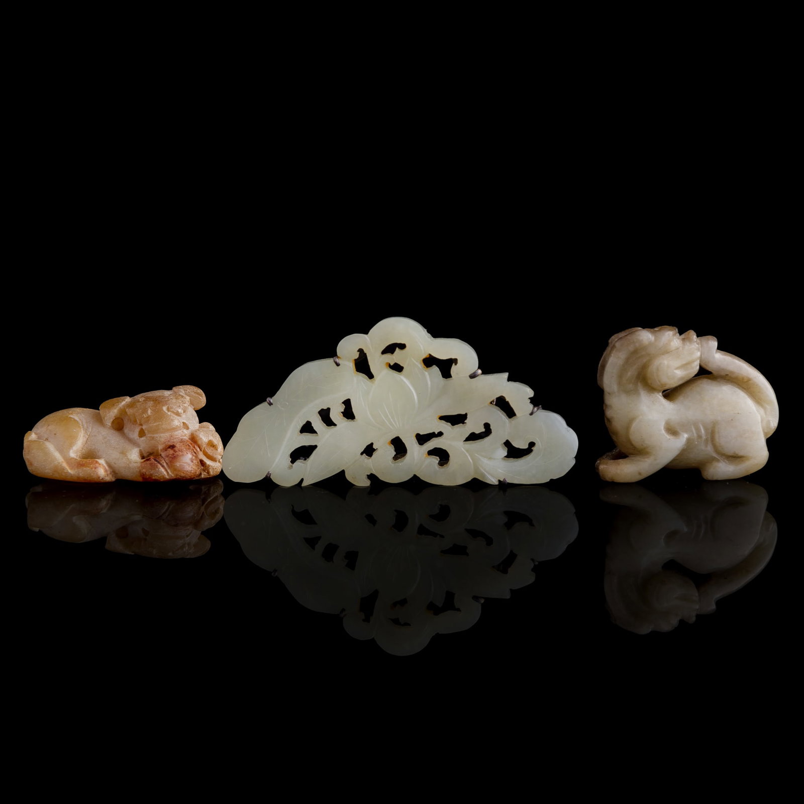 Two Chinese jade pendants and a white jade brooch, Ming/Qing dynasty: Two Chinese jade pendants and a white jade brooch Ming/Qing dynasty H: 1 1/4, W: 2 3/4, D: 3/8 in. (H: 3.2, W: 7, D: 1 cm. (brooch)) Private collection, New York.
