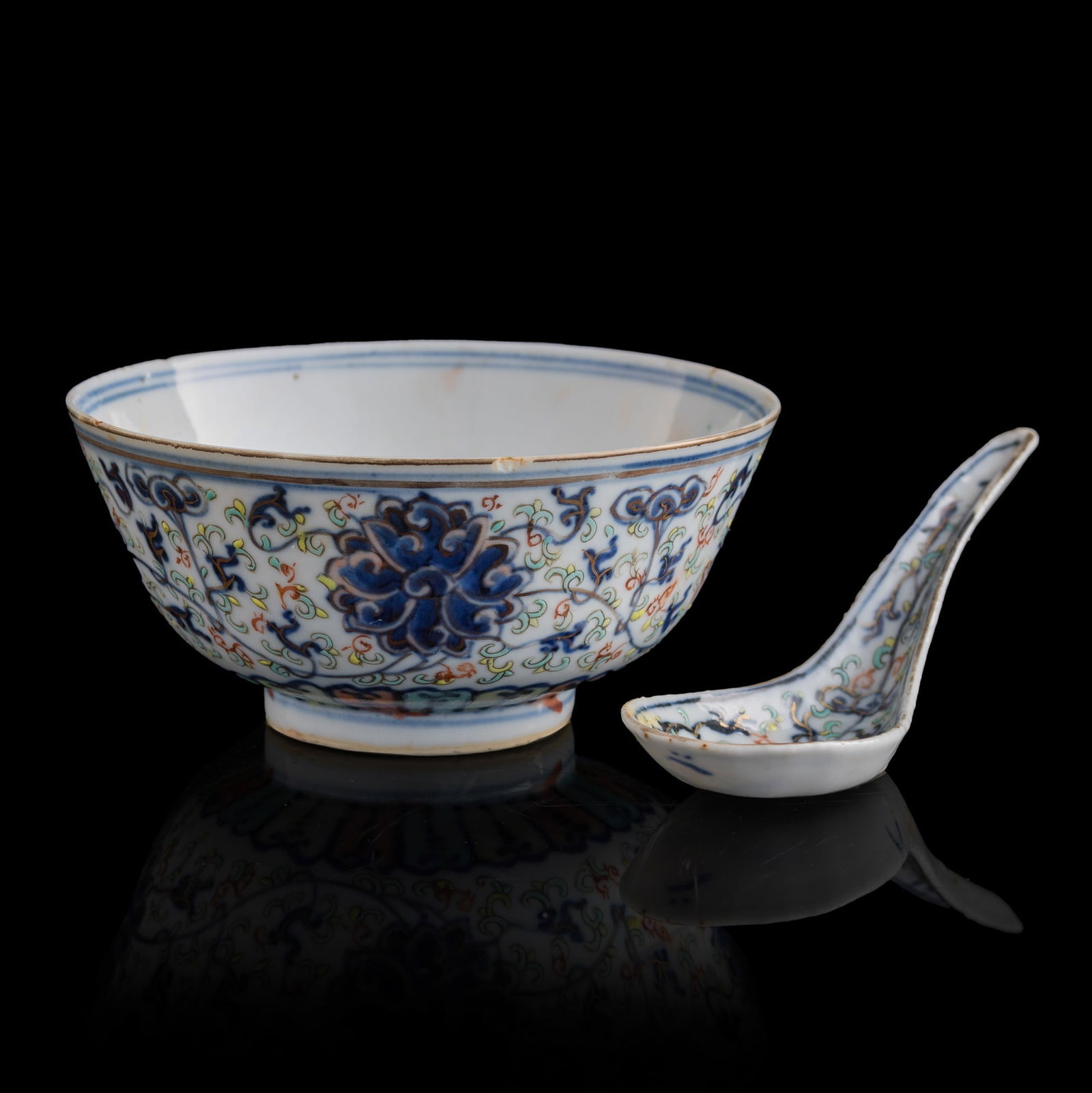 A Chinese blue and enamel 'scrolling lotus' bowl and a spoon, Guangxu period, Qing dynasty (1 of 9)