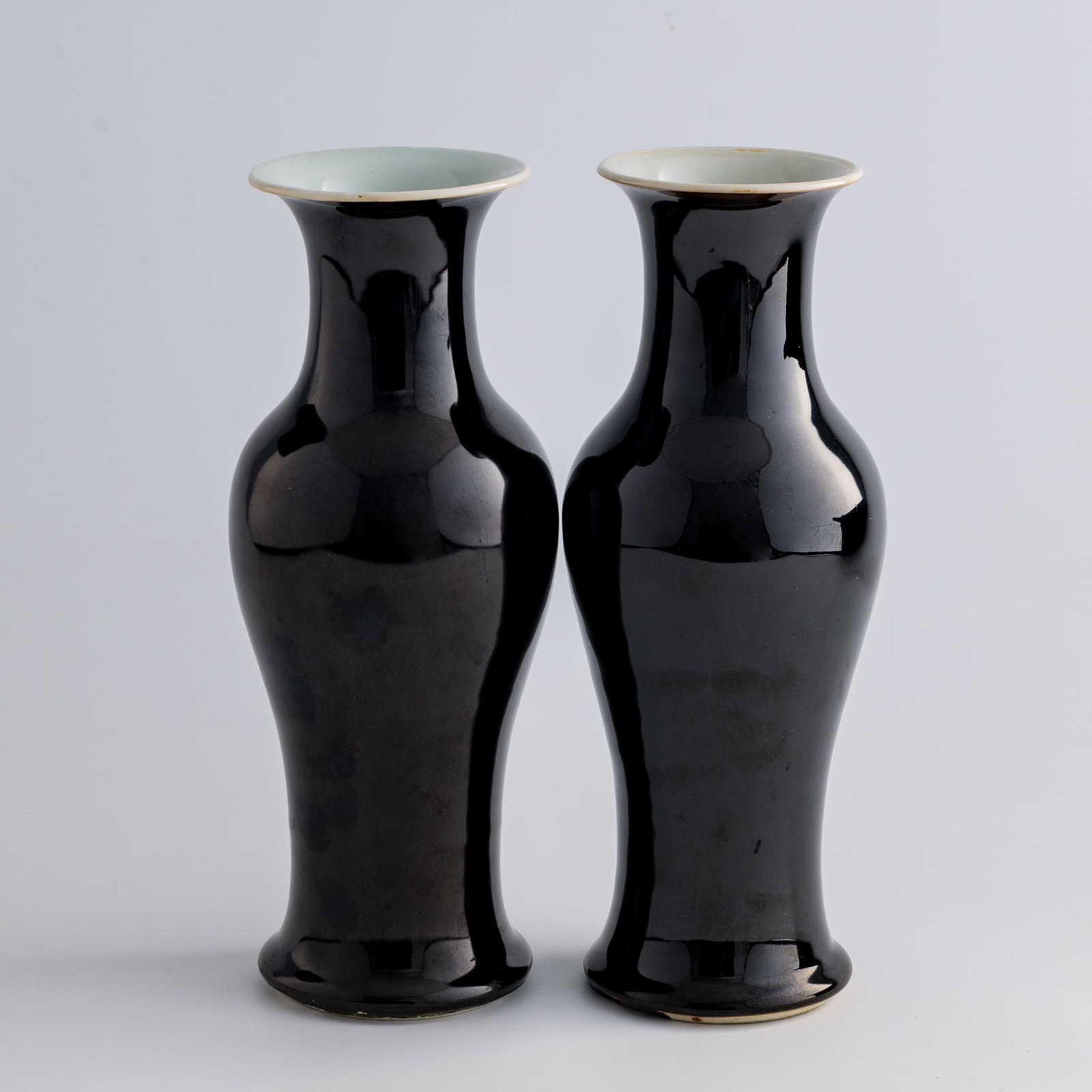 A pair of Chinese mirror-black-glazed Guanyin vases, late 19th century: A pair of Chinese mirror-black-glazed Guanyin vases late 19th century Each with six-character mark to underside. (2). H: 10 1/4, Dia: 4 in. (H: 26, Dia: 10.2 cm. (each)) Private collection, Dallas, Te