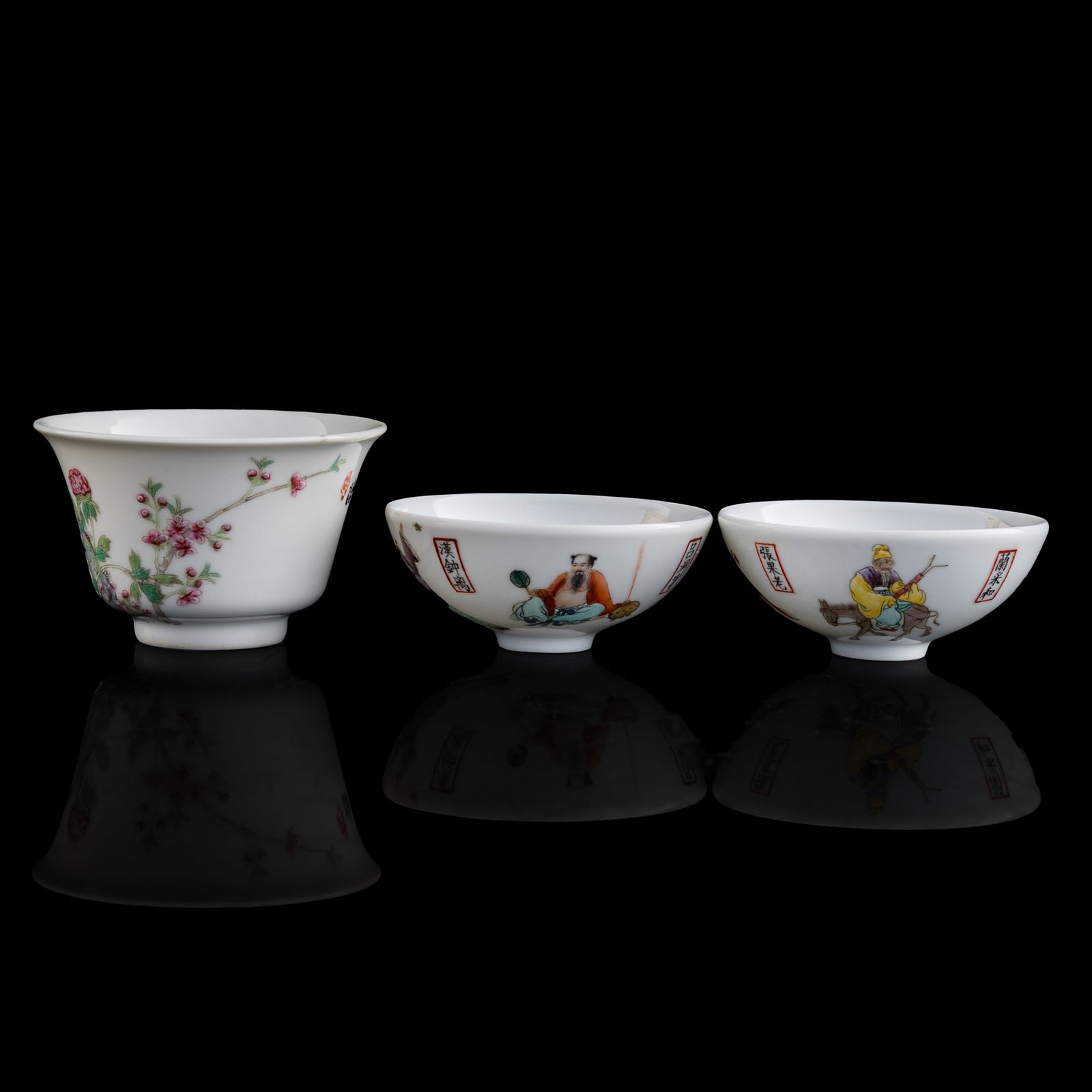 A Chinese cup and a pair of bowls, Contemporary: A Chinese cup and a pair of bowls Contemporary Pair of cups with four-character mark to underside, the other cup with six-character mark to underside. Sold with one associated box. (3). H: 2, Dia: 3 3