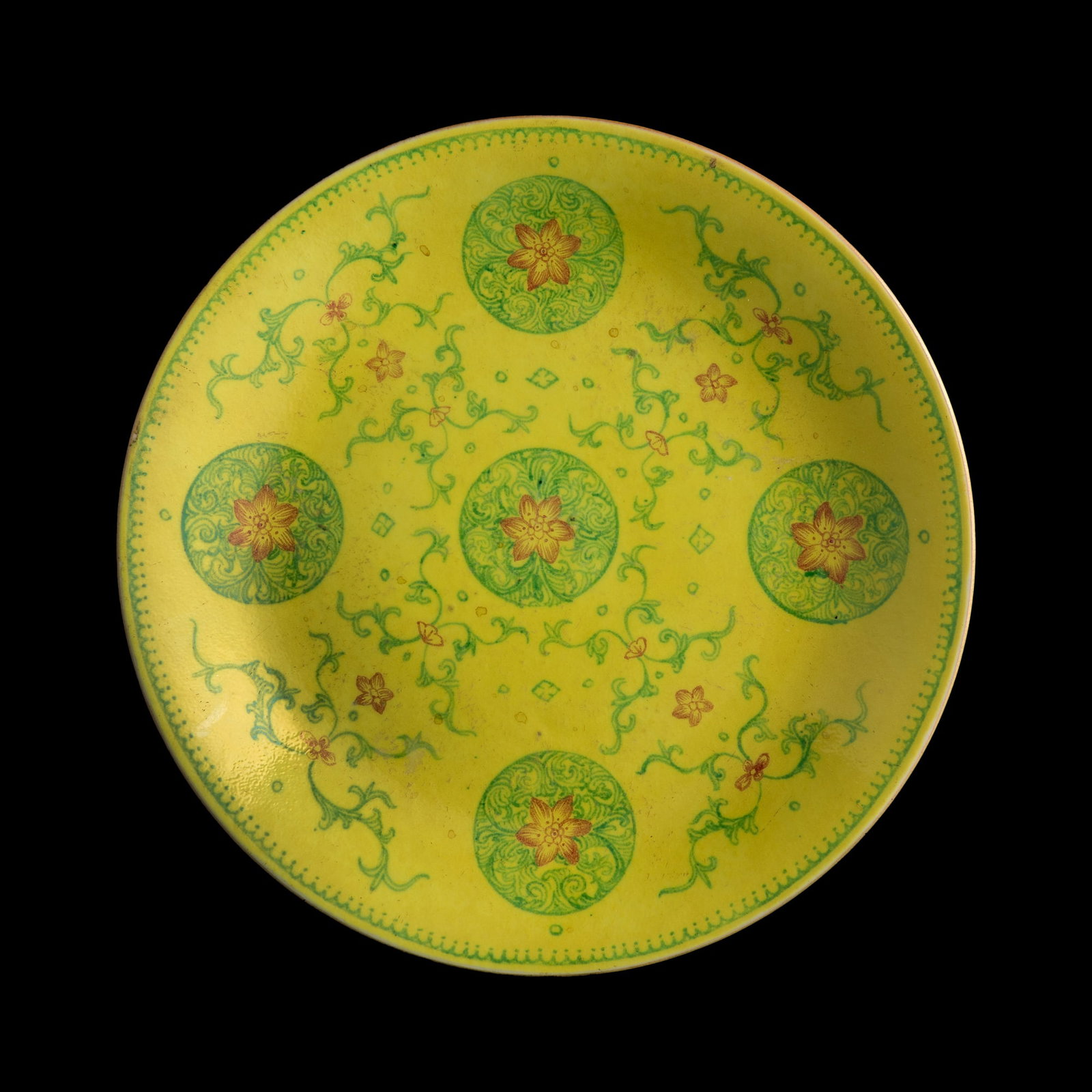 A Chinese yellow-ground famille rose 'floral medallions' plate, Qianlong period, Qing dynasty (1 of 7)