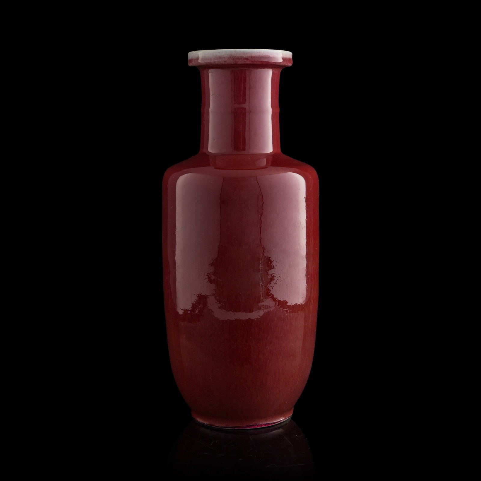 A Chinese red-glazed rouleau vase, 19th century: A Chinese red-glazed rouleau vase 19th century H: 17 5/8, Dia: 7 1/2 in. (H: 44.8, Dia: 19.1 cm.) Private collection, Dallas, Texas. Click here for high res