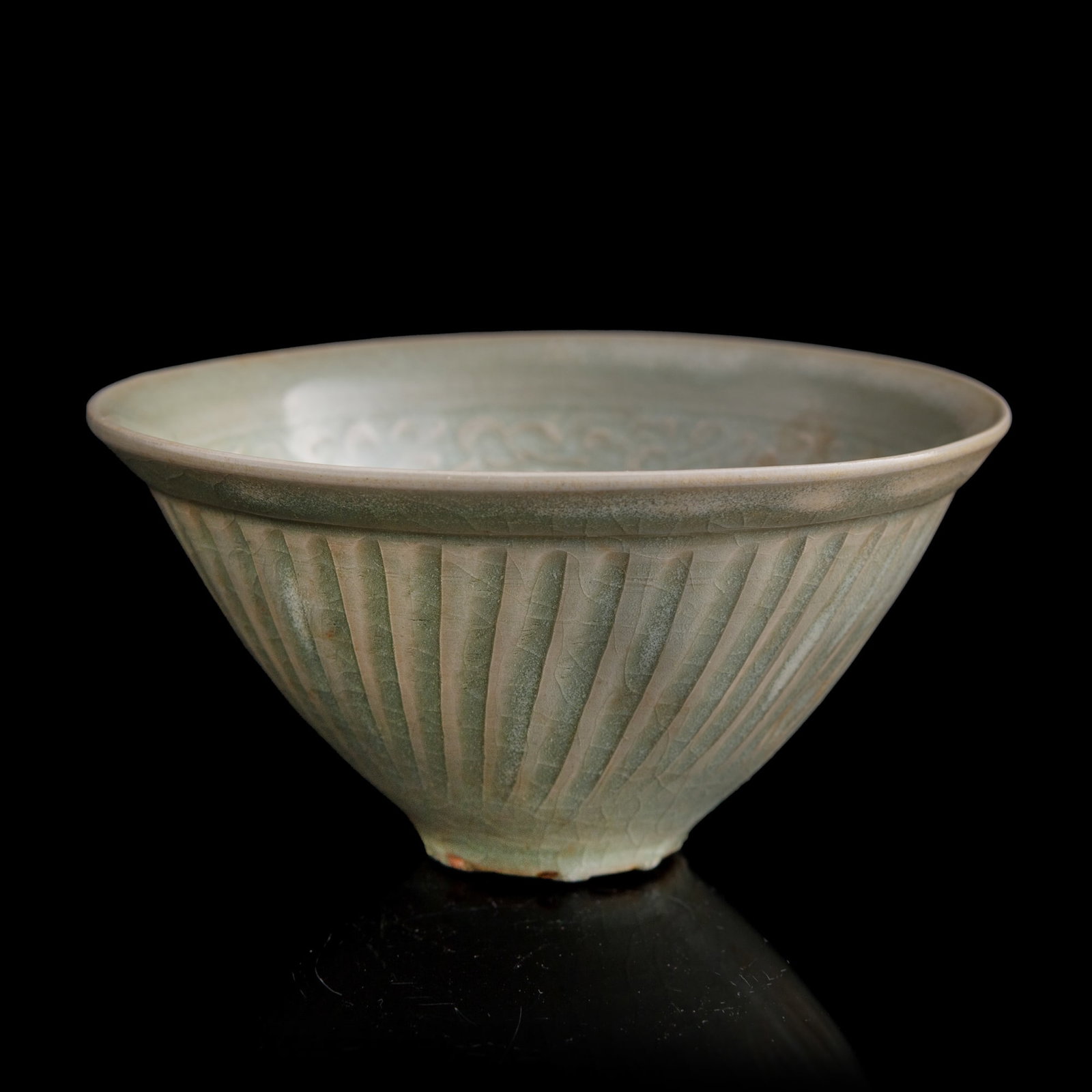 A Chinese Yaozhou ware 'scrolling flower' bowl, Song/Yuan dynasty: A Chinese Yaozhou ware 'scrolling flower' bowl Song/Yuan dynasty H: 2 1/2, Dia: 4 3/4 in. (H: 6.4, Dia: 12.1 cm.) Private collection, Gaithersburg, Maryland.