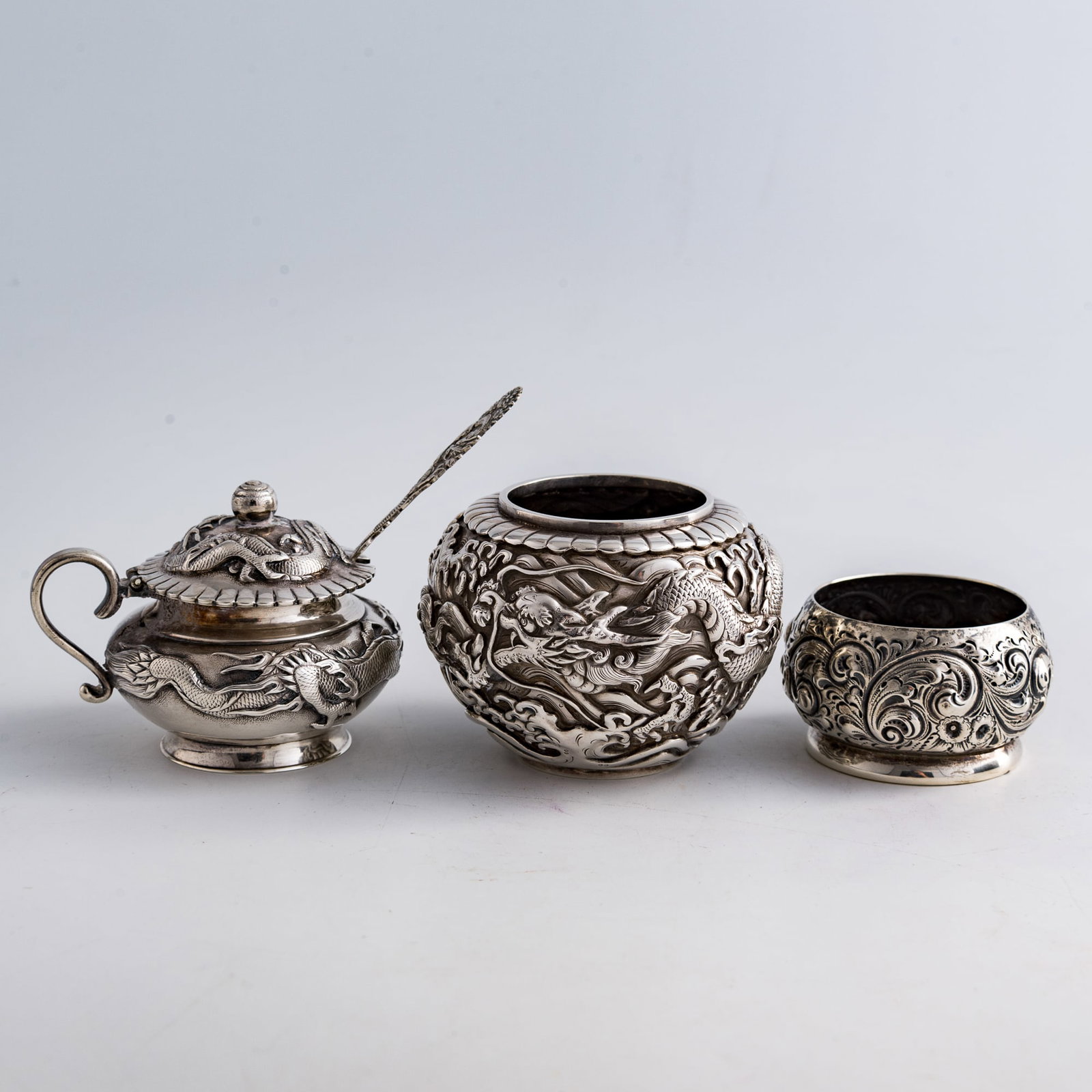 A group of three Japanese and American silver tea wares, late 19th century: A group of three Japanese and American silver tea wares late 19th century Comprising a sugar bowl, a spoon, and two small jars. Two with "Hongchi zao" and "chun yin" (pure silver) marks to underside, 