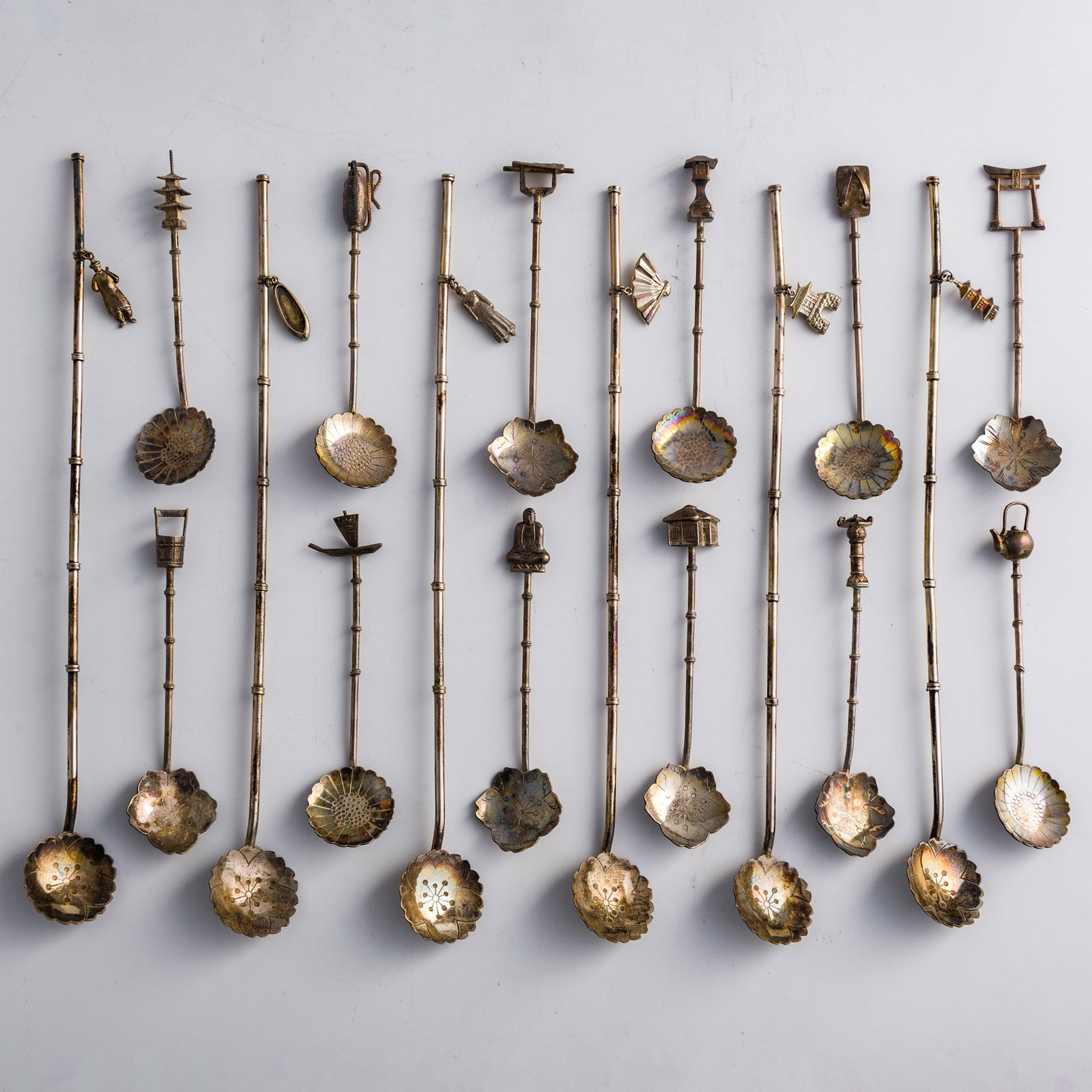 A collection of eighteen Japanese silver spoons, early 20th century: A collection of eighteen Japanese silver spoons early 20th century Each with either "Sterling Japan" or "95c Sterling" mark to reverse. (18). L: 8 3/4, W: 1, D: 1/2 in. (L: 22.2, W: 2.5, D: 1.3 cm. (l