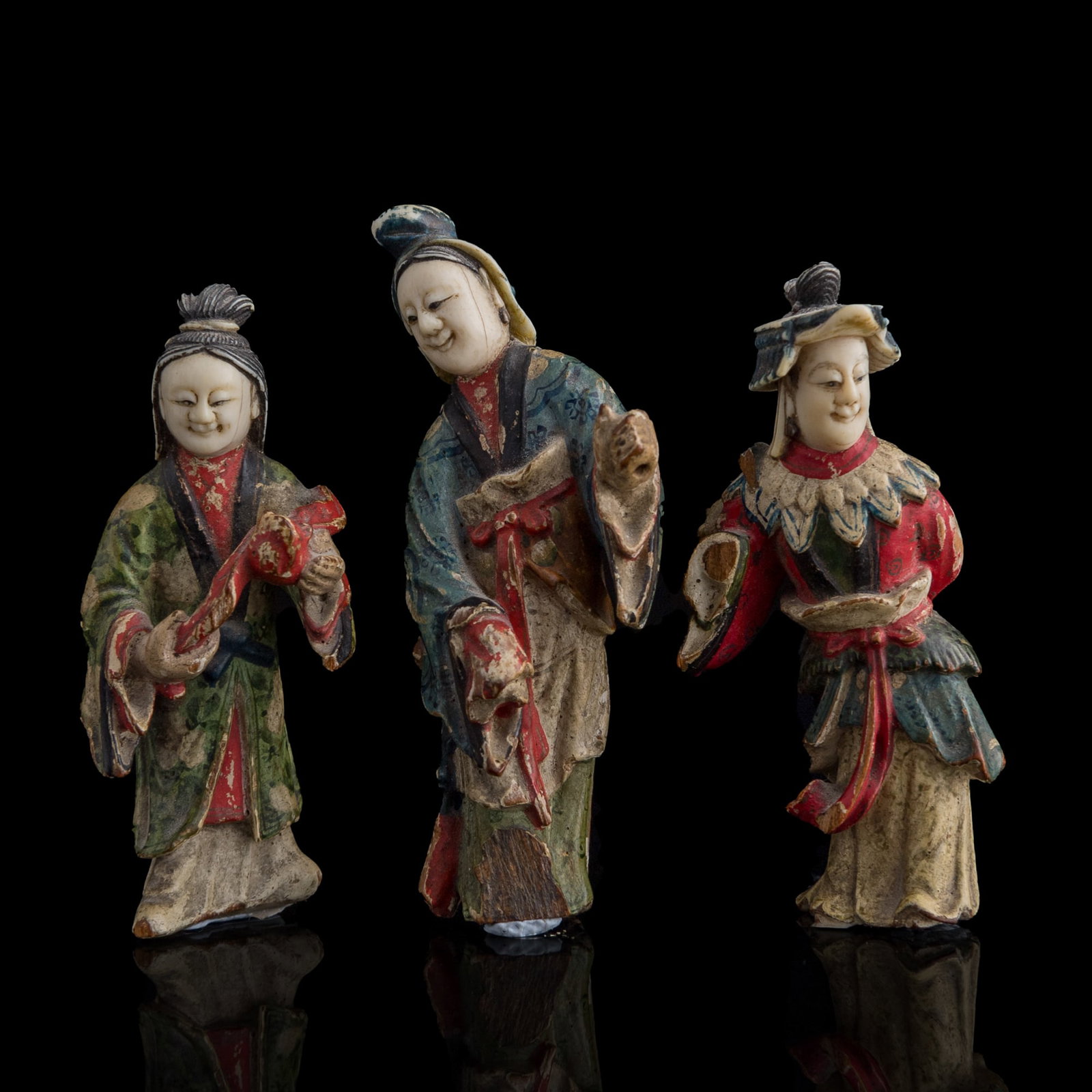 A set of three Chinese polychrome wood figures with inset heads, Qing dynasty/Republic period: A set of three Chinese polychrome wood figures with inset heads Qing dynasty/Republic period H: 3, W: 1 3/8, D: 1 in. (H: 7.6, W: 3.5, D: 2.5 cm. (tallest)) From an estate in the Washington, D.C. area
