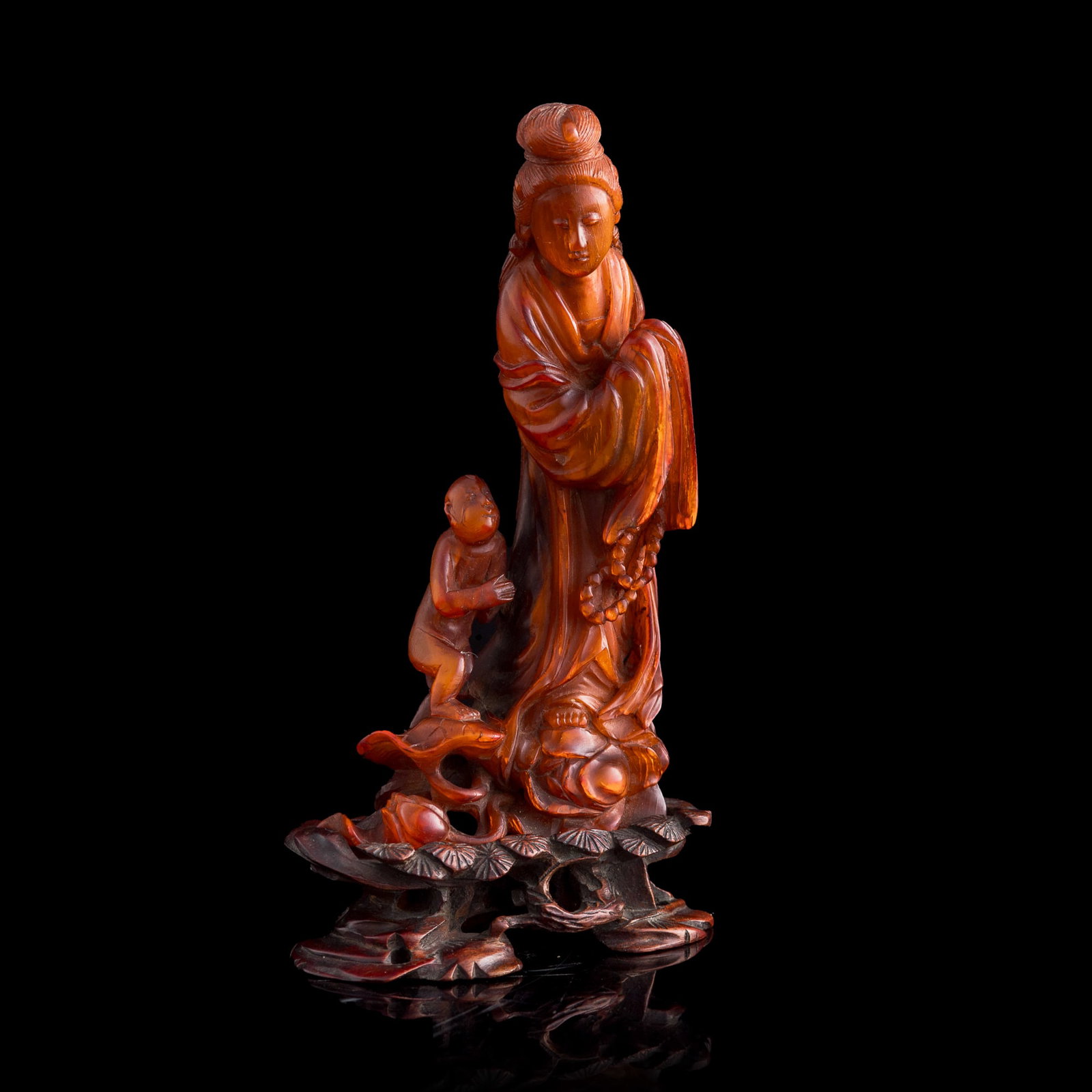 A Chinese ox horn carving of Guanyin, Republic period: A Chinese ox horn carving of Guanyin Republic period Sold with original hardwood stand. H: 7, W: 3 5/8, D: 2 1/8 in. (H: 17.8, W: 9.2, D: 5.4 cm. (overall)) Private collection, Winter Springs, Florida