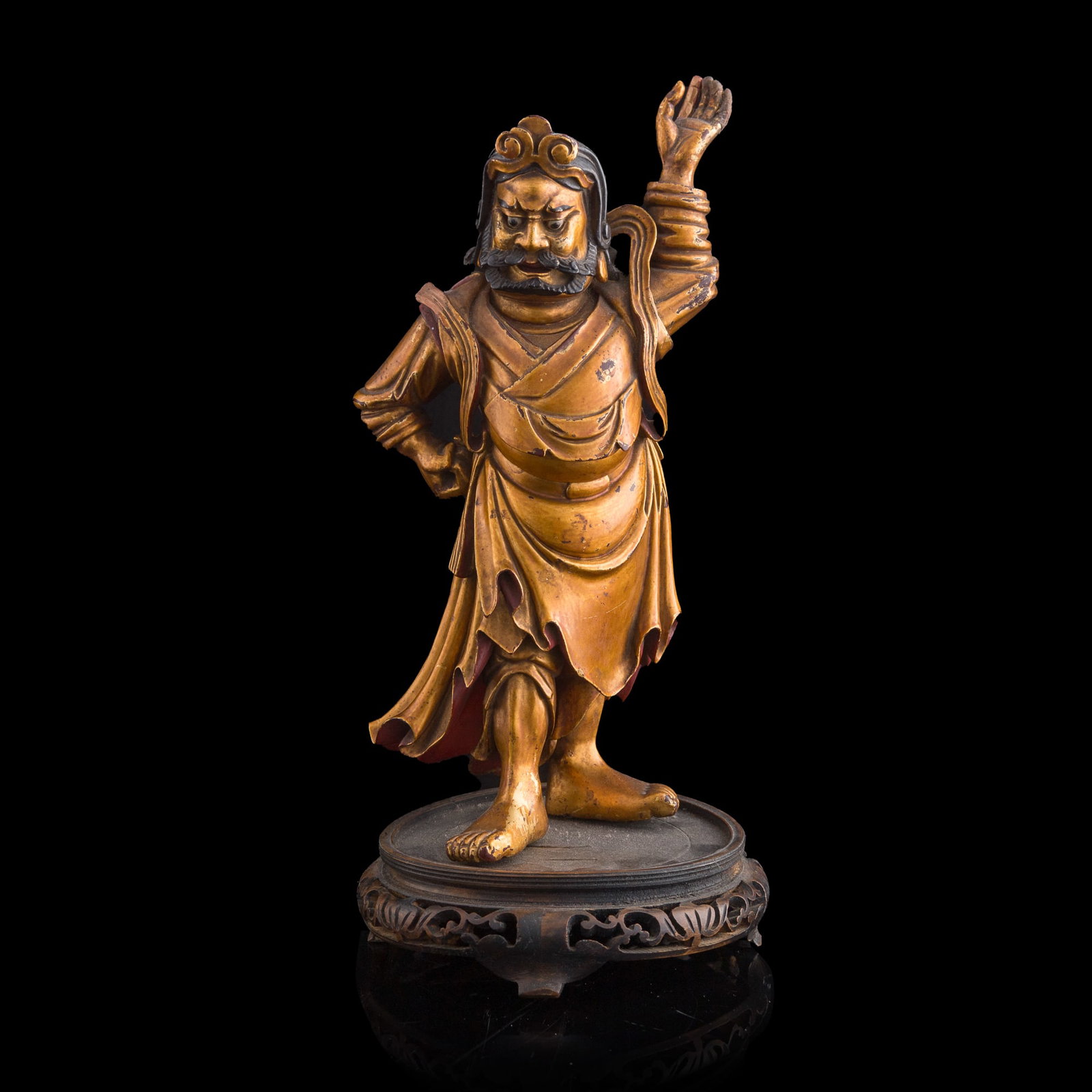 A Chinese gilt-lacquered wood figure of a Guardian King, early 19th century: A Chinese gilt-lacquered wood figure of a Guardian King early 19th century Sold with an affixed wooden stand. Overall dimensions: H: 13 3/4, W: 7 1/2, D: 6 3/8 in. (H: 34.9, W: 19.1, D: 16.2 cm.) Priv