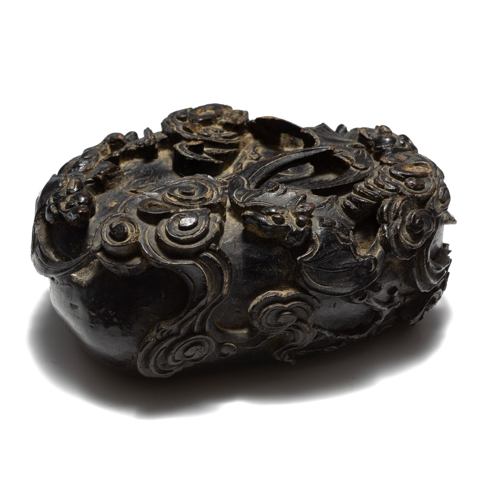 A Chinese peach-form 'cloud and bat' wooden stand, 19th century: A Chinese peach-form 'cloud and bat' wooden stand 19th century H: 2 1/2, W: 6 3/8, D: 5 3/4 in. (H: 6.4, W: 16.2, D: 14.6 cm.) Private collection, Tampa, Florida.