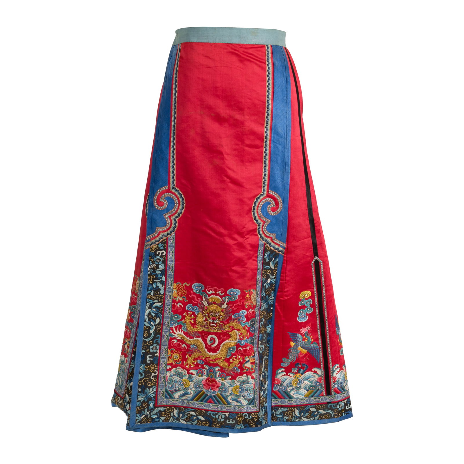 A Chinese red-ground embroidered skirt, 19th century: A Chinese red-ground embroidered skirt 19th century Decorated with a dragon pursuing a flaming pearl on the front panel, framed by two blue-ground ruyi borders. H: 35, W: 46 in. (H: 88.9, W: 116.8 cm.