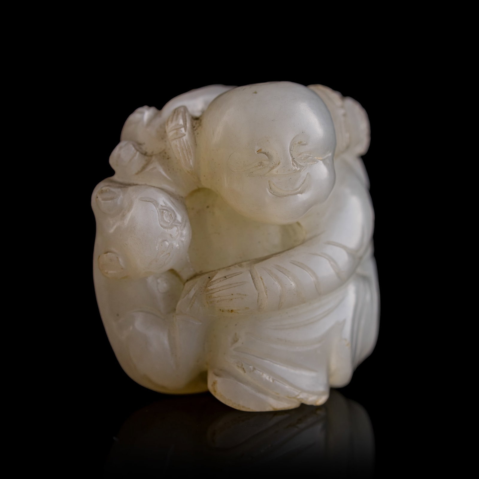 A Chinese white jade 'boy' pendant, 18th century: A Chinese white jade 'boy' pendant 18th century H: 1 1/2, W: 1 1/2, D: 1 in. (H: 3.8, W: 3.8, D: 2.5 cm.) From Mr. Kwok of Vancouver, Canada. Inherited from his late father, who acquired the items in