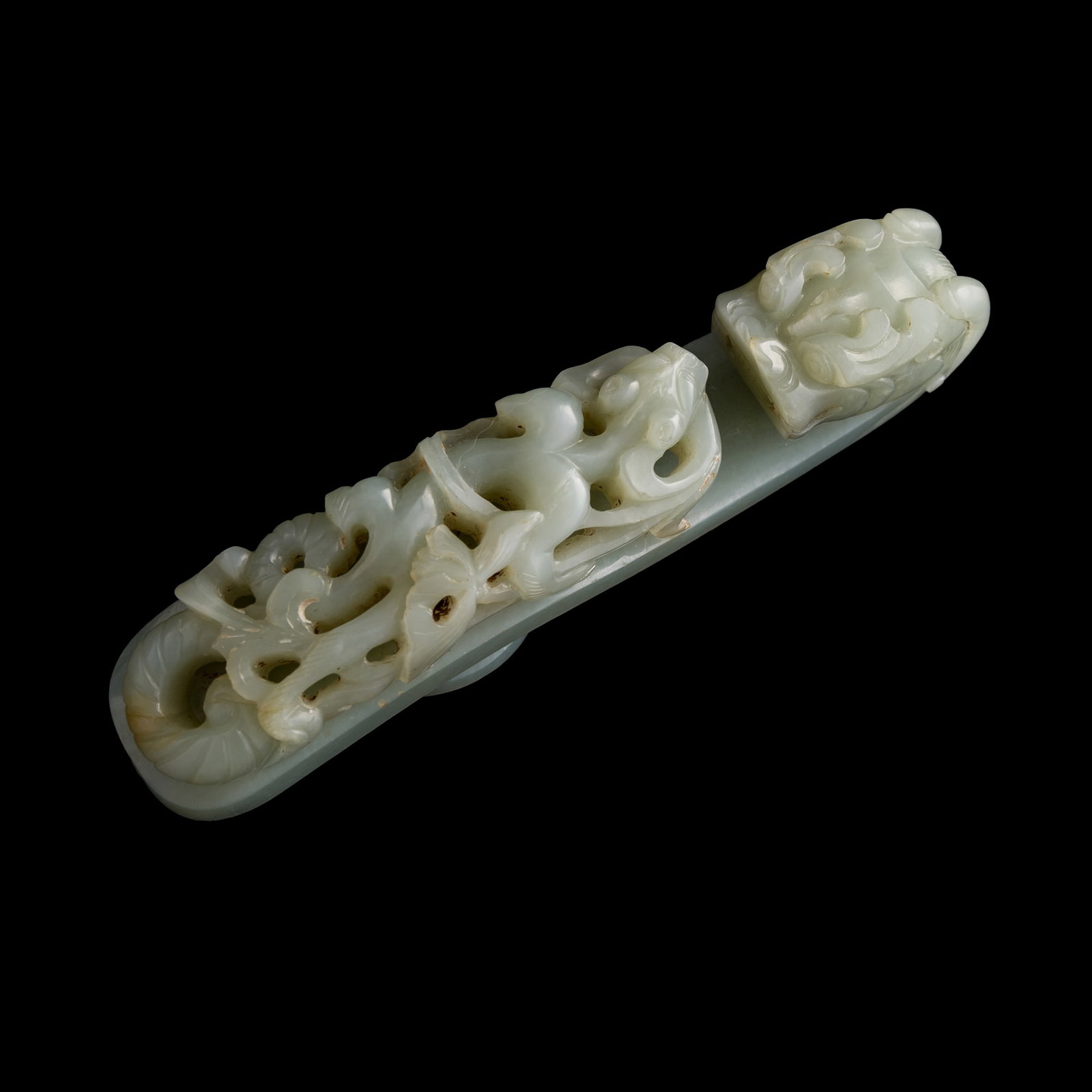 A Chinese jade dragon belt hook, Ming dynasty: A Chinese jade dragon belt hook Ming dynasty H: 1 1/4, W: 1 1/8, D: 5 1/8 in. (H: 3.2, W: 2.9, D: 13 cm.) From Mr. Kwok of Vancouver, Canada. Inherited from his late father, who acquired the items in
