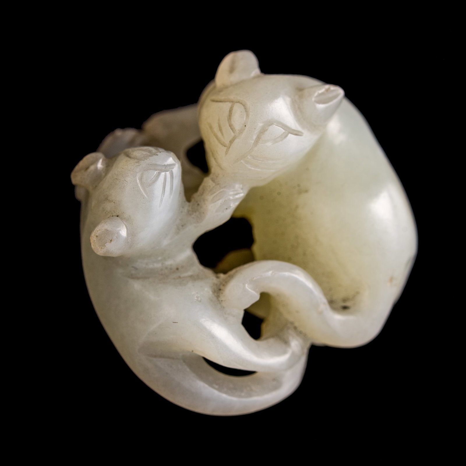 A Chinese white jade 'double badger' pendant, early 19th century: A Chinese white jade 'double badger' pendant early 19th century H: 1, W: 1 3/8, D: 1 3/8 in. (H: 2.5, W: 3.5, D: 3.5 cm.) From Mr. Kwok of Vancouver, Canada. Inherited from his late father, who
