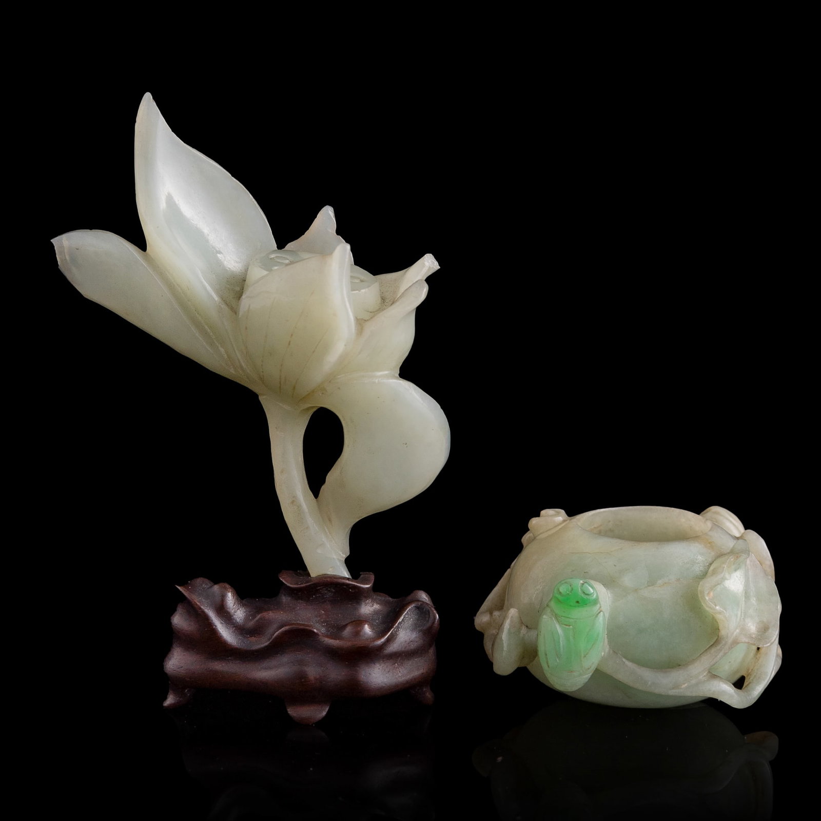 A Chinese jadeite water coupe and a white jade lotus carving, 19th century: A Chinese jadeite water coupe and a white jade lotus carving 19th century Sold with associated wooden stand. (2). H: 3 3/4, W: 2 1/2, D: 1 3/8 in. (H: 9.5, W: 6.4, D: 3.5 cm. (largest, overall)) From 