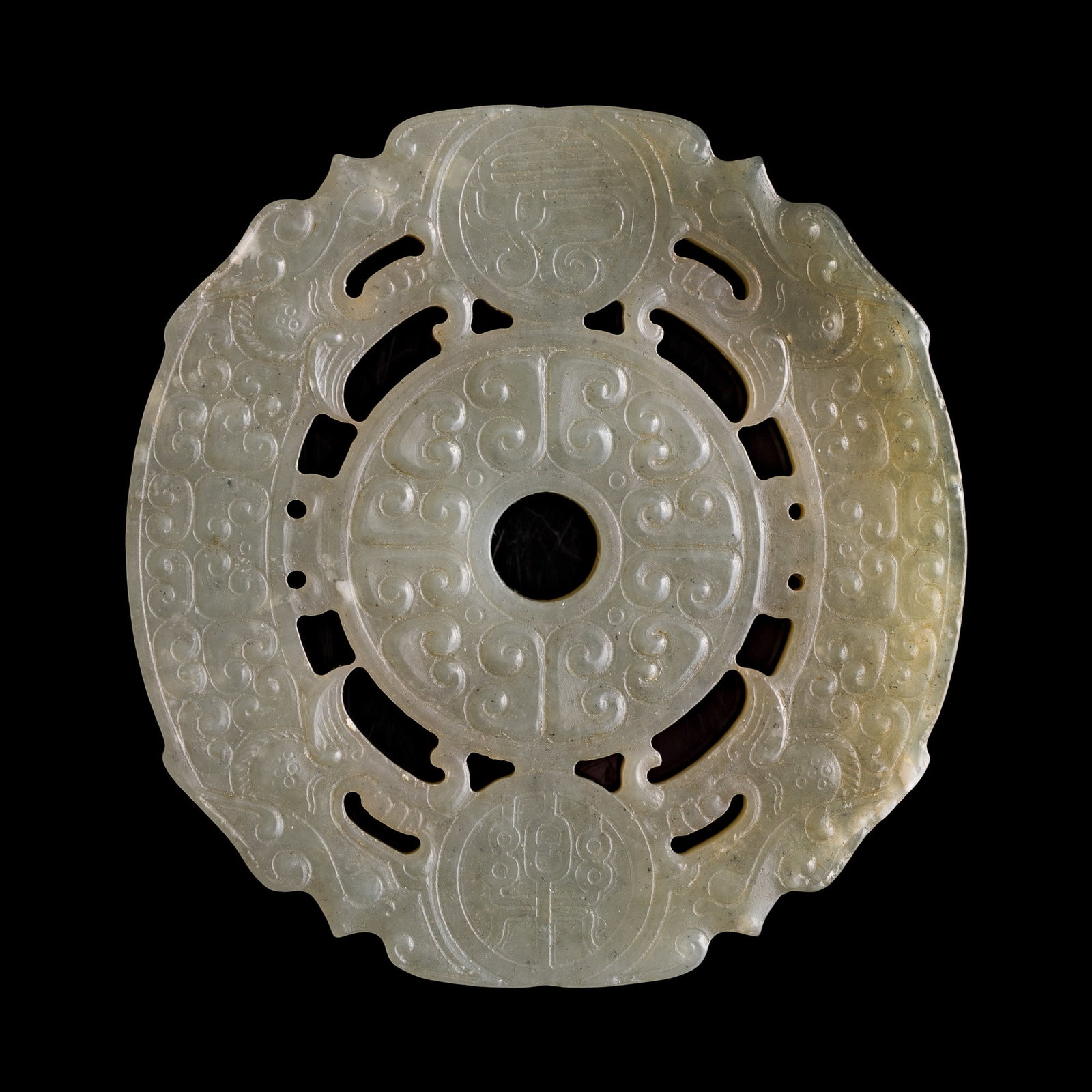 A Chinese carved jade double-huang bi disc with 'chilong', 18th century: A Chinese carved jade double-huang bi disc with 'chilong' 18th century H: 1/8, Dia: 2 3/8 in. (H: 0.3, Dia: 6 cm.) From an estate in Detroit, Michigan. Click here for high resolution images.
