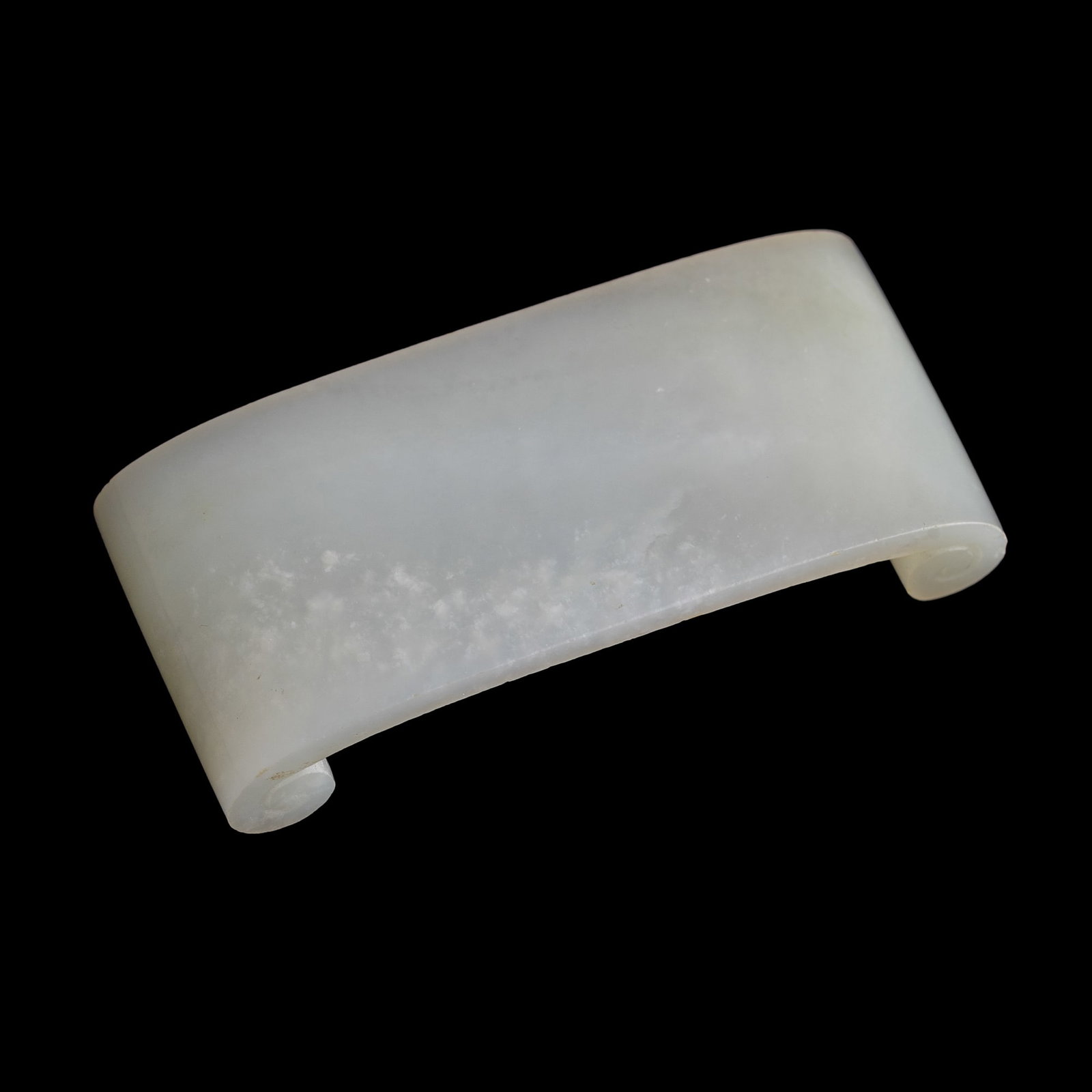 A Chinese white jade inkstick rest, 18th century: A Chinese white jade inkstick rest 18th century H: 1/2, W: 2 7/8, D: 1 1/4 in. (H: 1.3, W: 7.3, D: 3.2 cm.) Private collection, Florida. Click here for high resolu