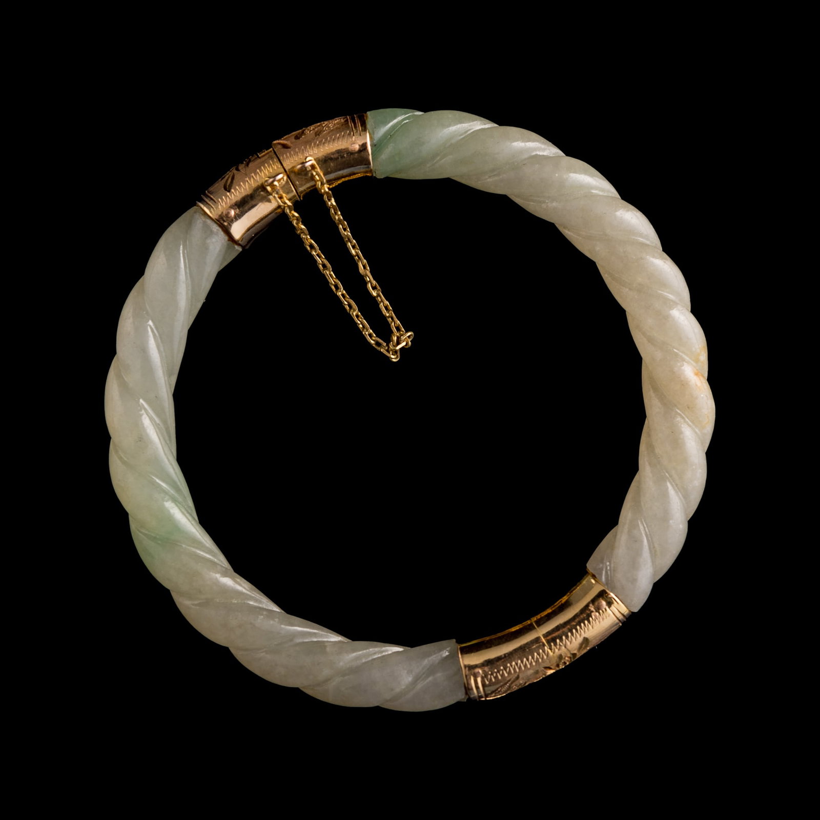 A Chinese jadeite twisted bangle, Qing dynasty: A Chinese jadeite twisted bangle Qing dynasty Inner Dia: 61.8, Outer Dia: 80 mm From Mrs. Hillebrand of Chicago, Illinois. Her father-in-law acquired these items in China and Hong Kong between 1935 an