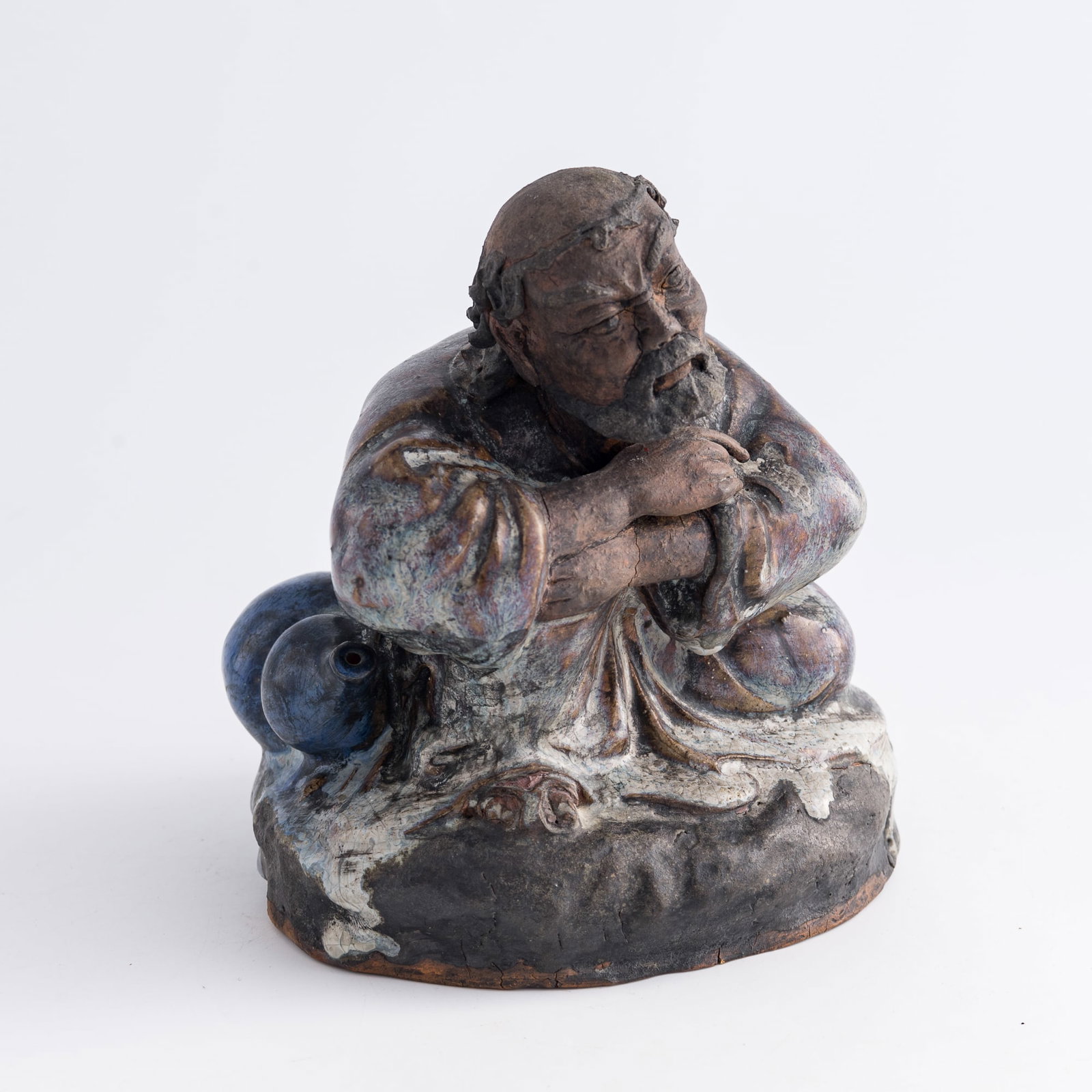 A Chinese Shiwan seated figure of Bodhidharma, Qing dynasty: A Chinese Shiwan seated figure of Bodhidharma Qing dynasty figure is seated with arms crossed H: 6 1/2, W: 5 1/2, D: 5 1/4 in. (H: 16.5, W: 14, D: 13.3 cm.) From Mrs. Cheng of Daly City, California. T