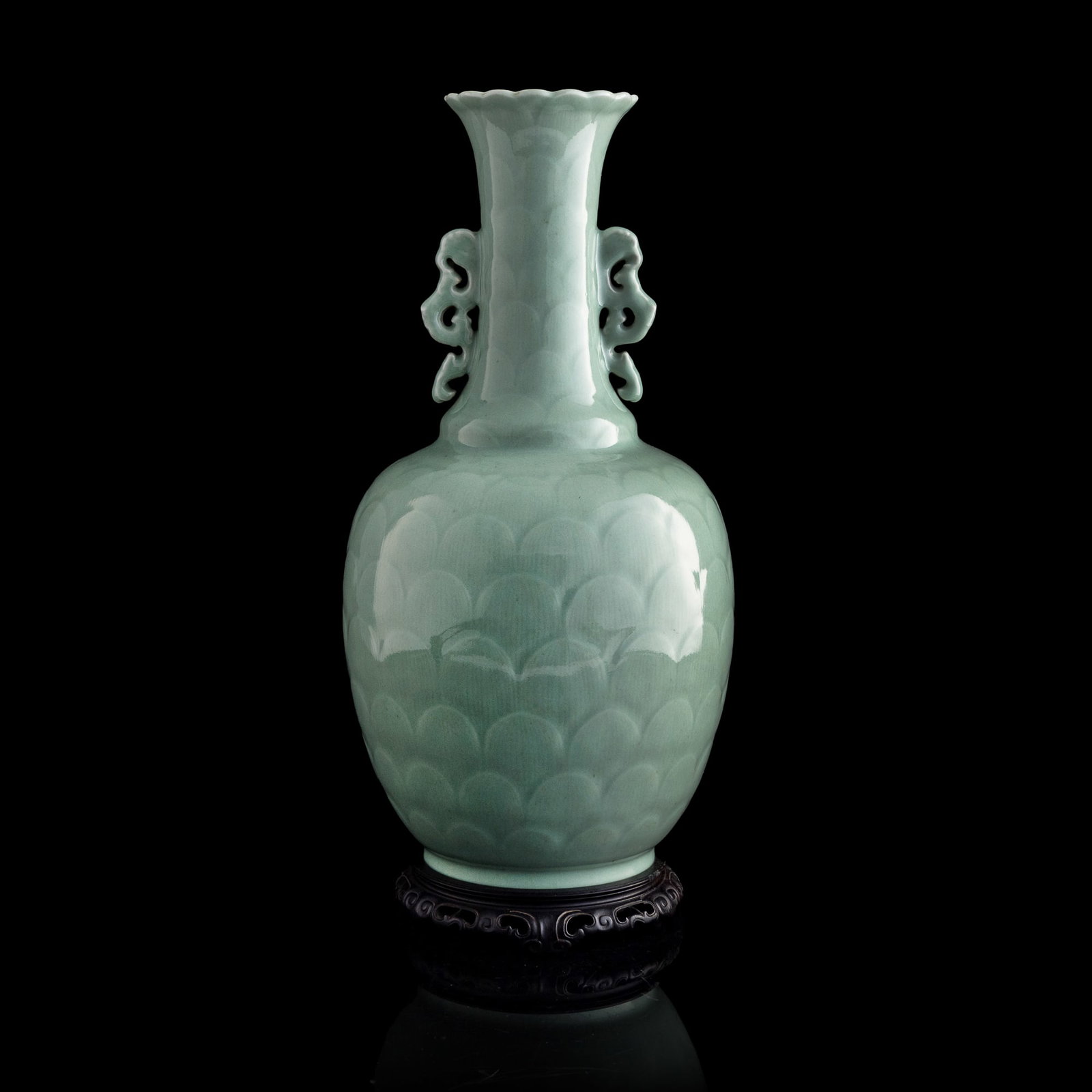 A Chinese celadon-glazed 'lotus-petal' vase, Qianlong period, Qing dynasty: A Chinese celadon-glazed 'lotus-petal' vase Qianlong period, Qing dynasty With six-character Qianlong mark to underside. Sold with a hardwood stand. H: 17 1/8, Dia: 8 1/2 in. (H: 43.5, Dia: 21.6 cm.) 
