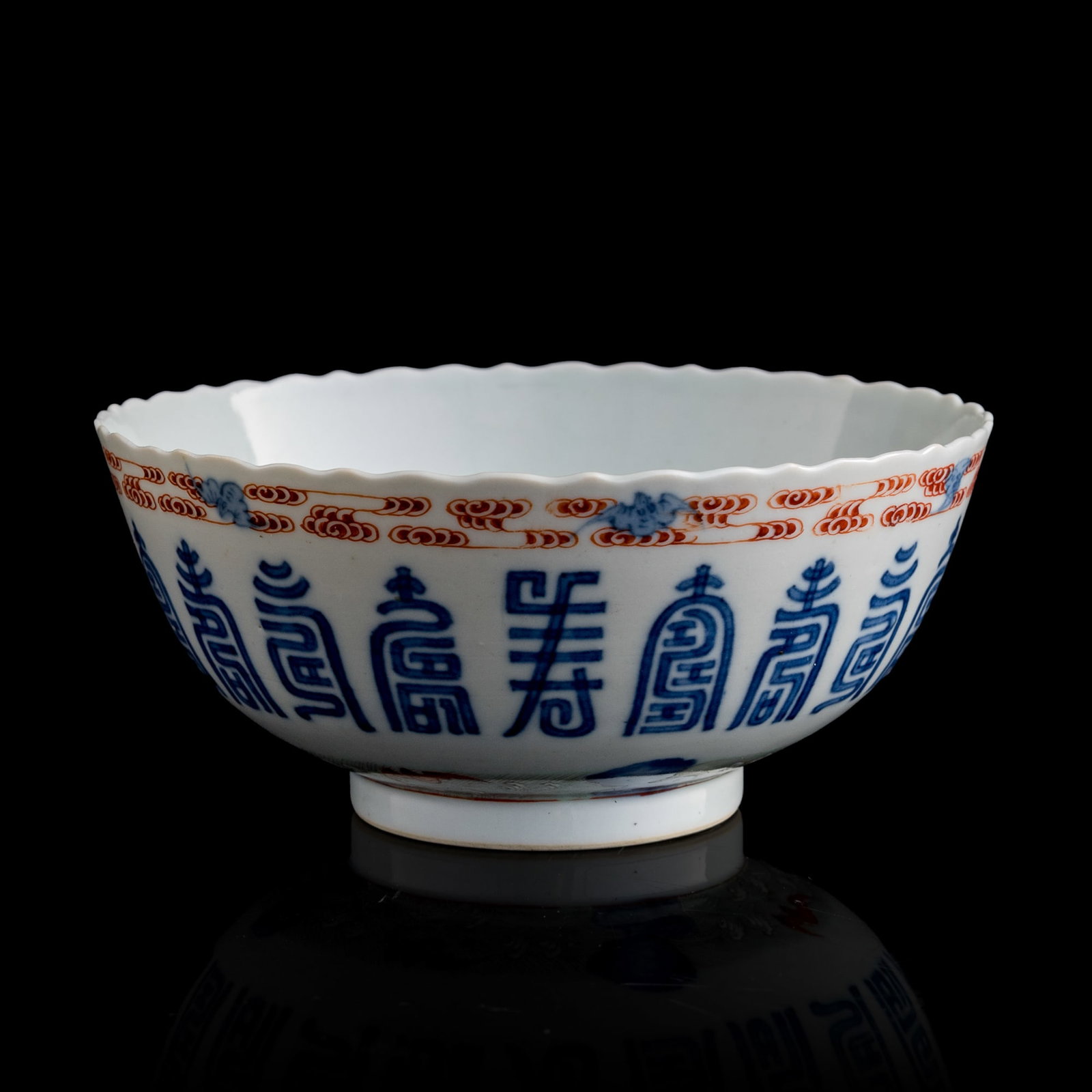 A Chinese blue and polychrome-enameled 'fu shou' bowl, early 19th century: A Chinese blue and polychrome-enameled 'fu shou' bowl early 19th century With a 'bat and peach' motif to underside. H: 3, Dia: 6 5/8 in. (H: 7.6, Dia: 16.8 cm.) From Mrs. Foo of Vancouver, Canada. Inh